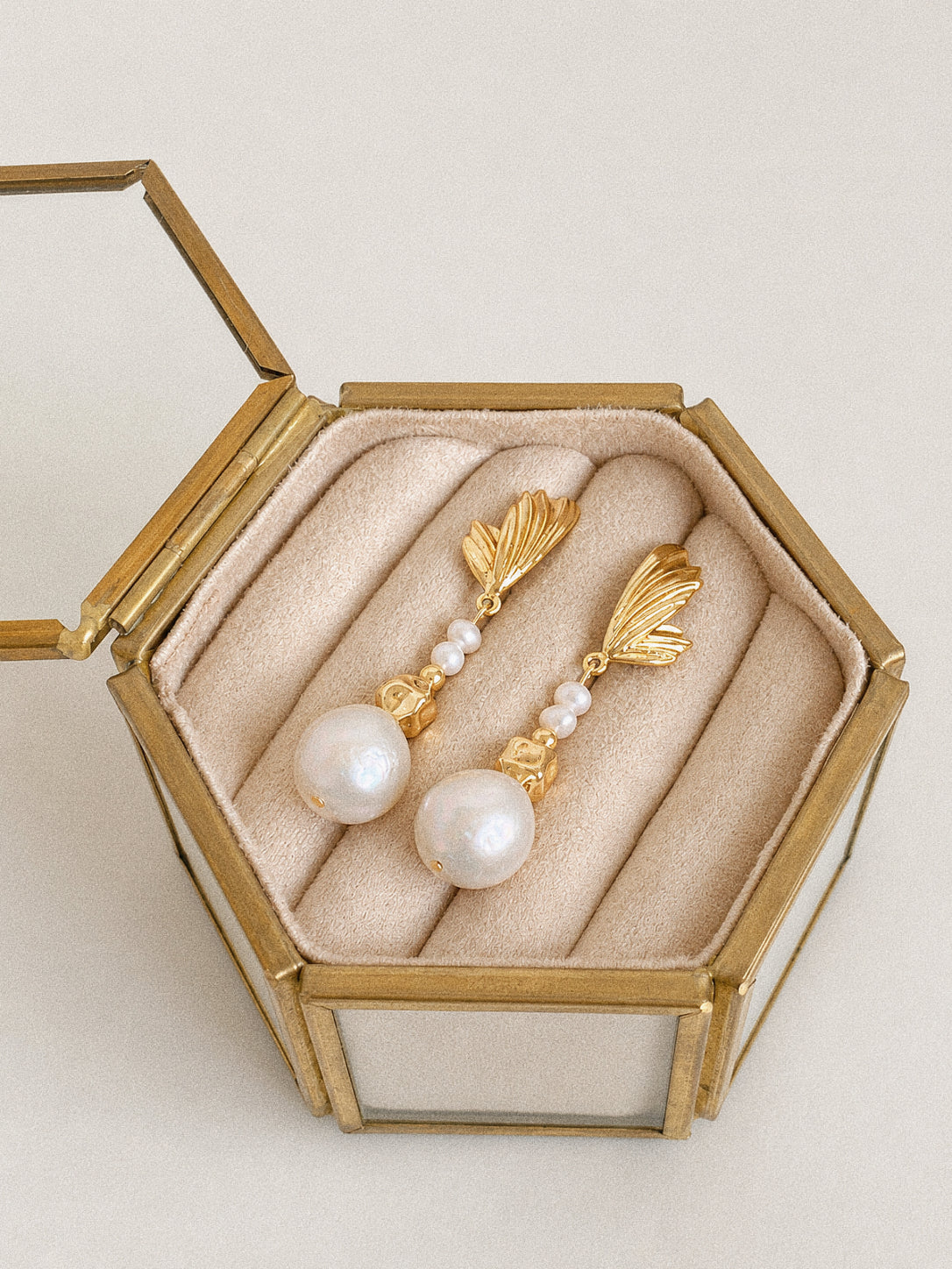 Linden gold leaf and freshwater baroque pearl earrings presented as a pair in a vintage-style jewellery box.