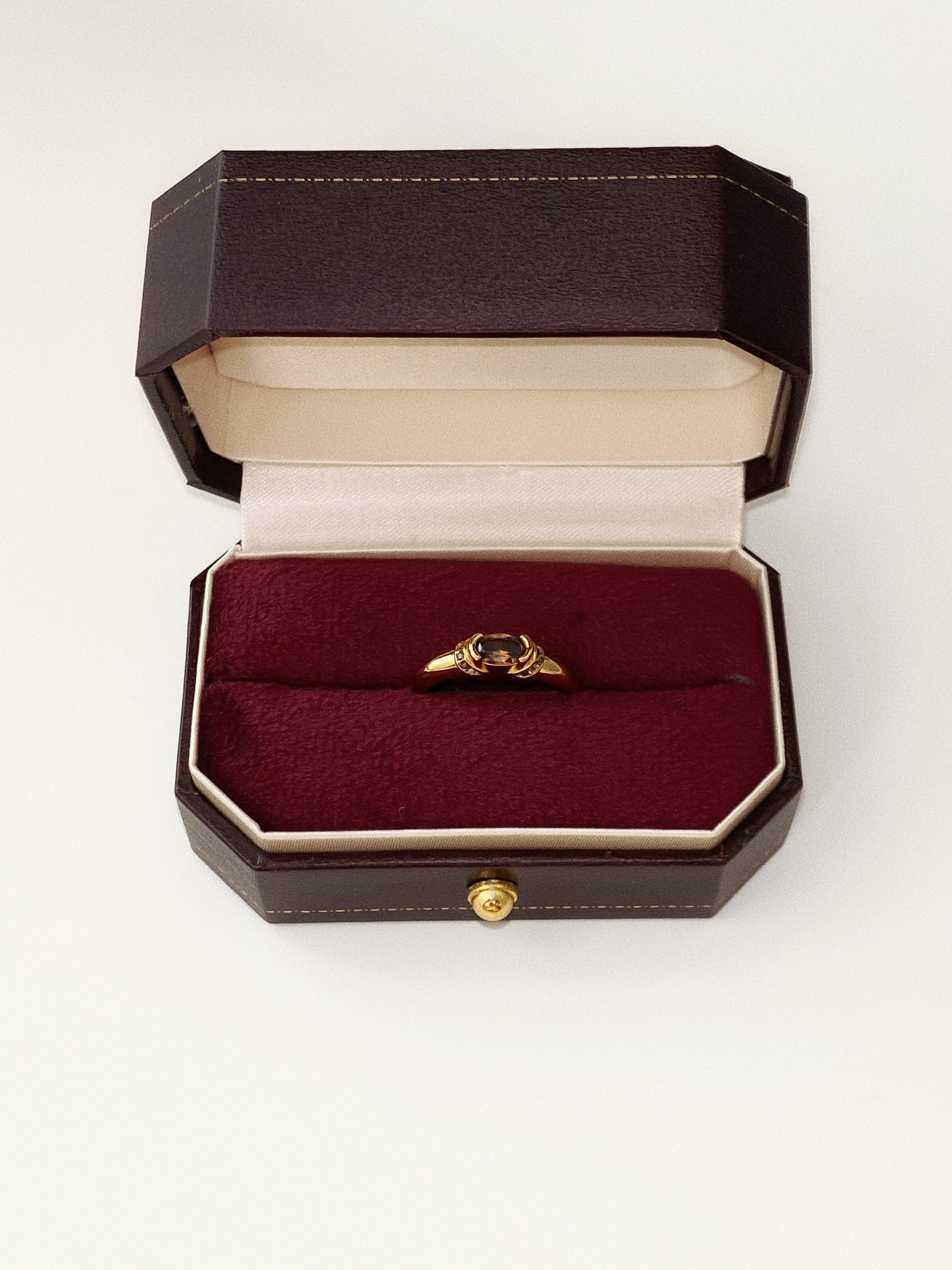 Top-down view of the vintage oval gemstone ring in its box, ready for gifting.