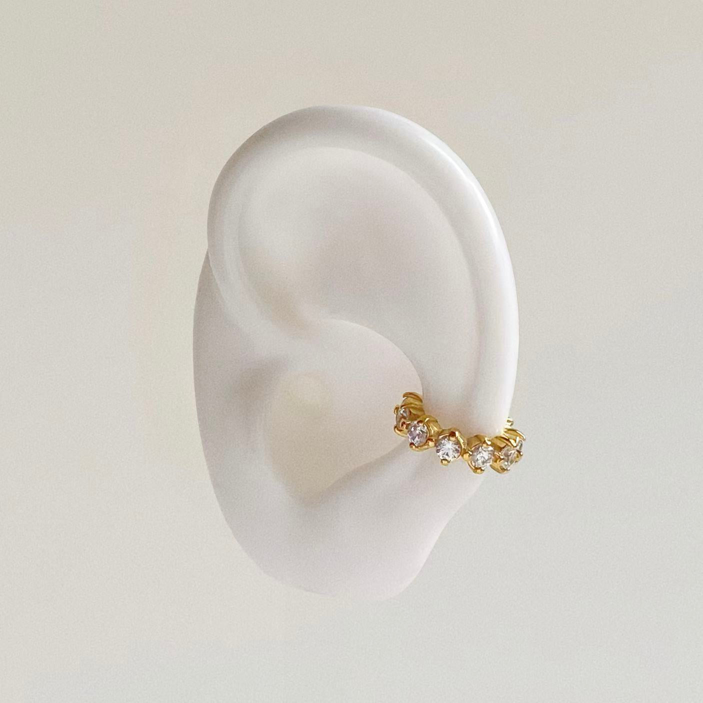 Mannequin ear showing how to wear a crystal ear cuff on the conch cartilage without piercing.