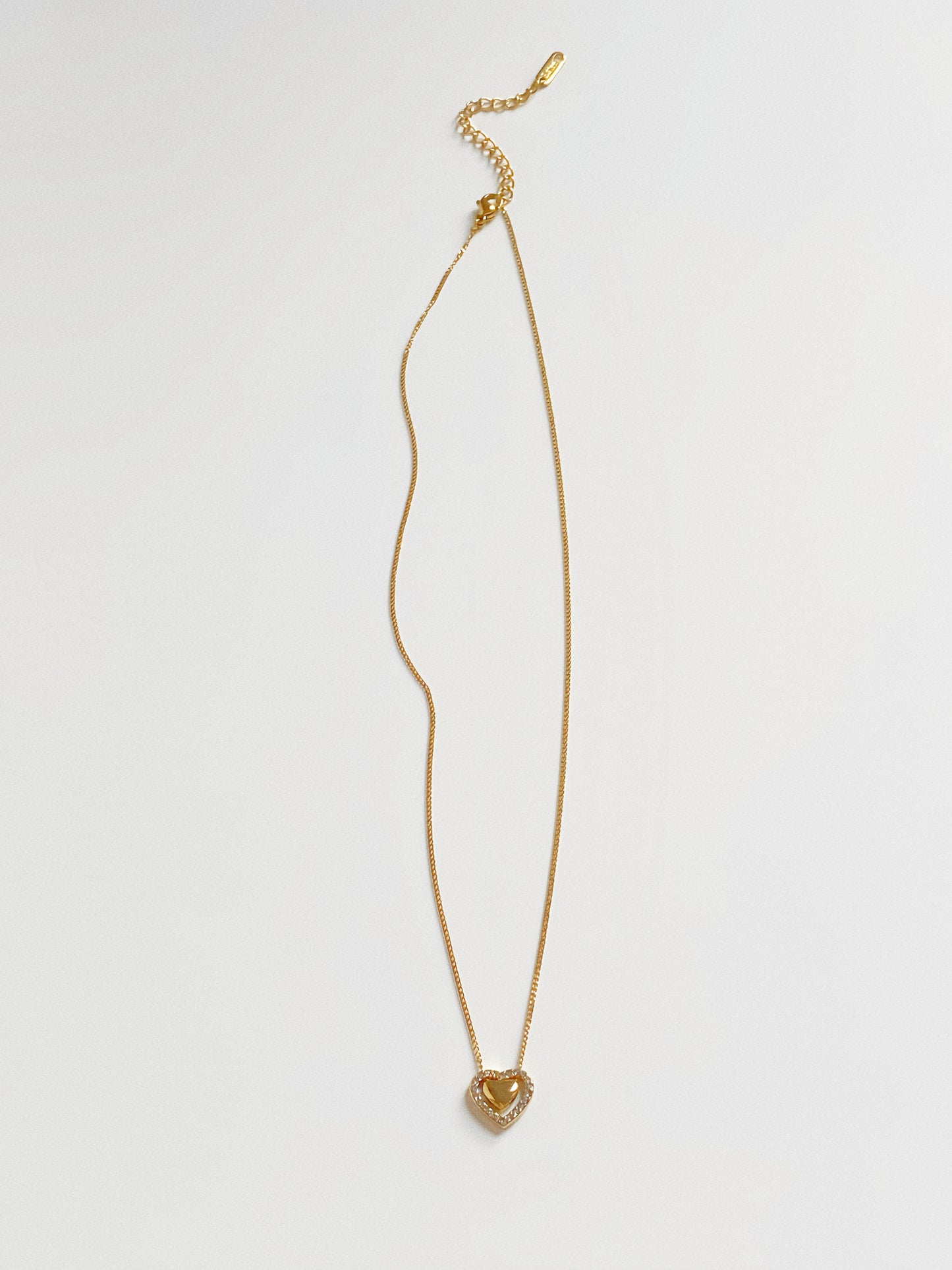 Gold chain necklace with a double heart pendant design, waterproof and hypoallergenic for daily wear.