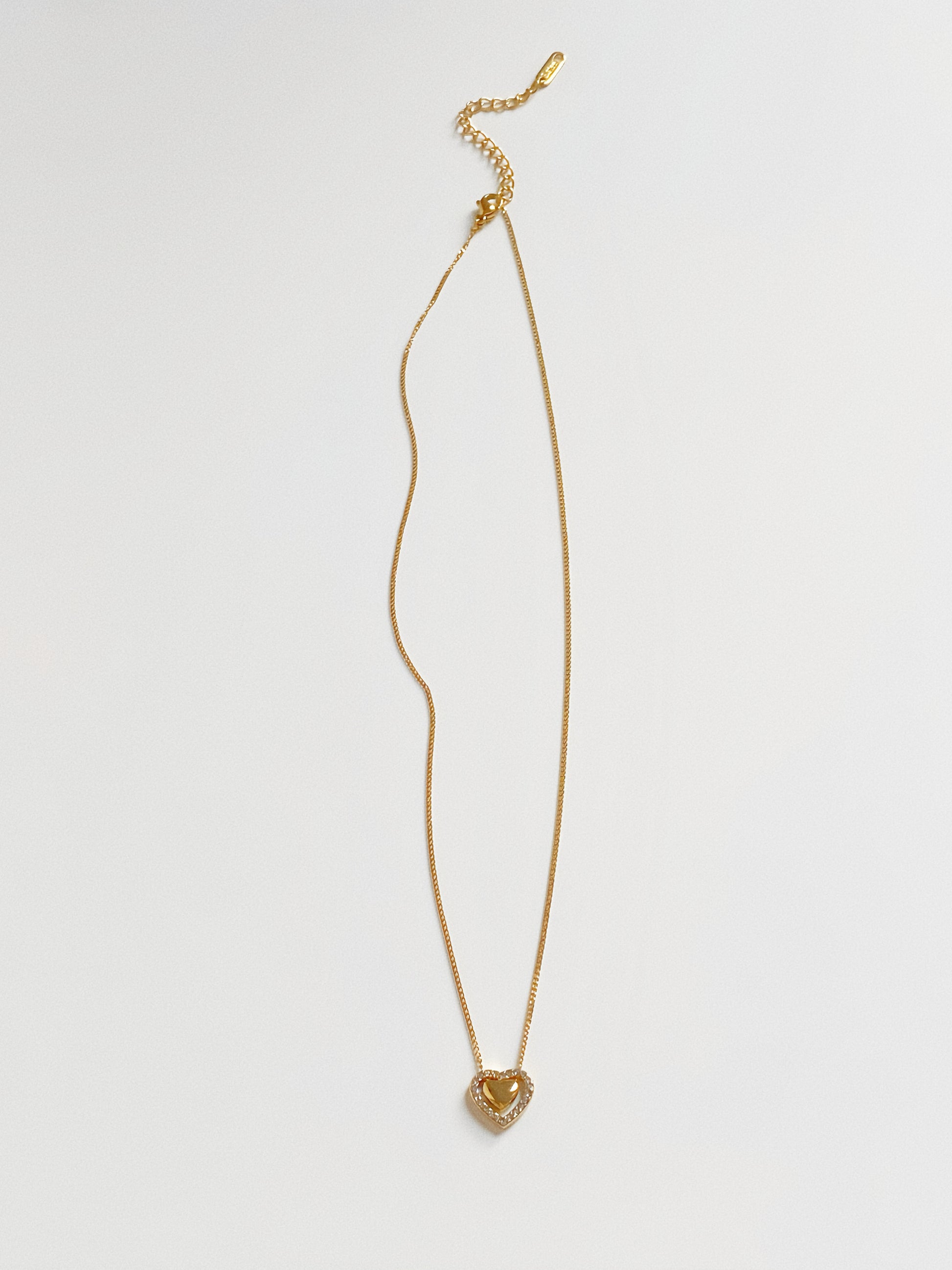 Gold chain necklace with a double heart pendant design, waterproof and hypoallergenic for daily wear.