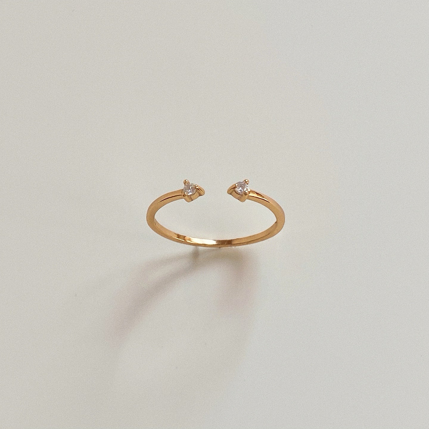Front view of Duo Sparkle dainty gold pinky ring standing upright