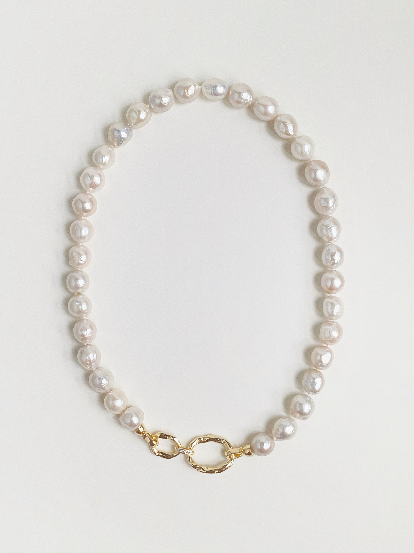 Grand Baroque freshwater pearl necklace with hammered gold double-link front clasp flat lay by Deja Vu Jewellery