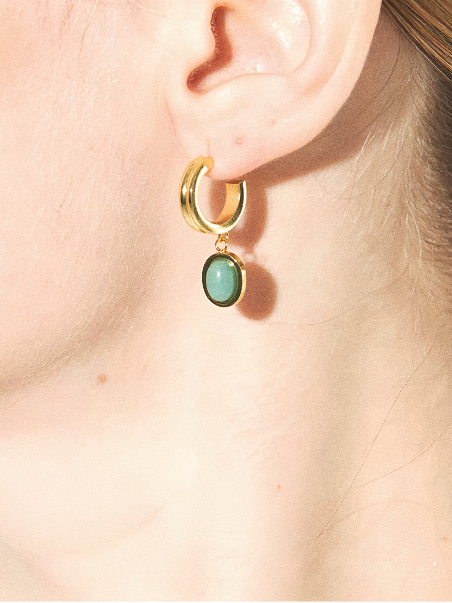 Detailed side view of the aventurine dangle earrings, showing the high-shine gold hoops.