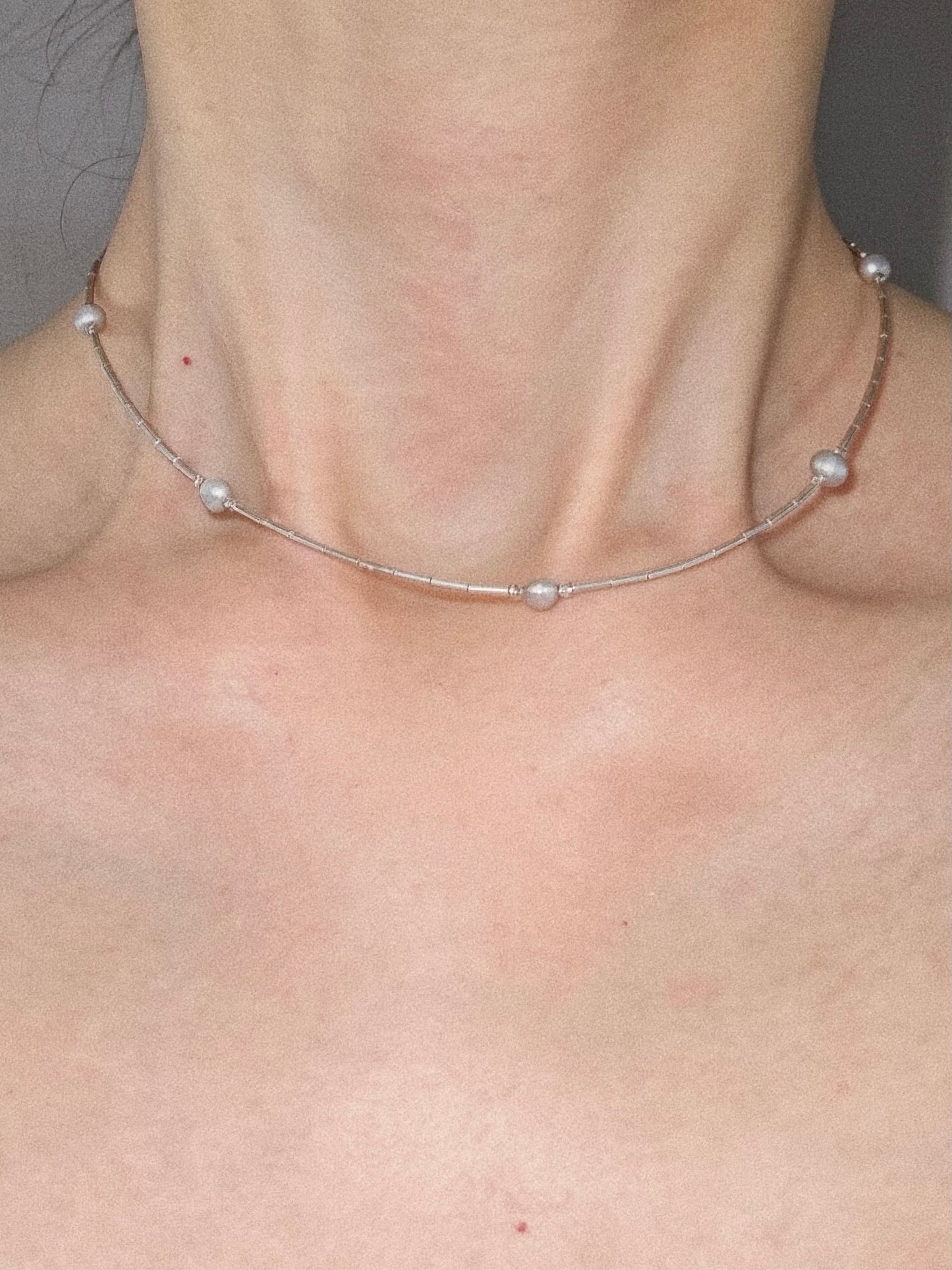 Natural grey pearl 925 silver station necklace styled on model as a dainty choker for everyday wear