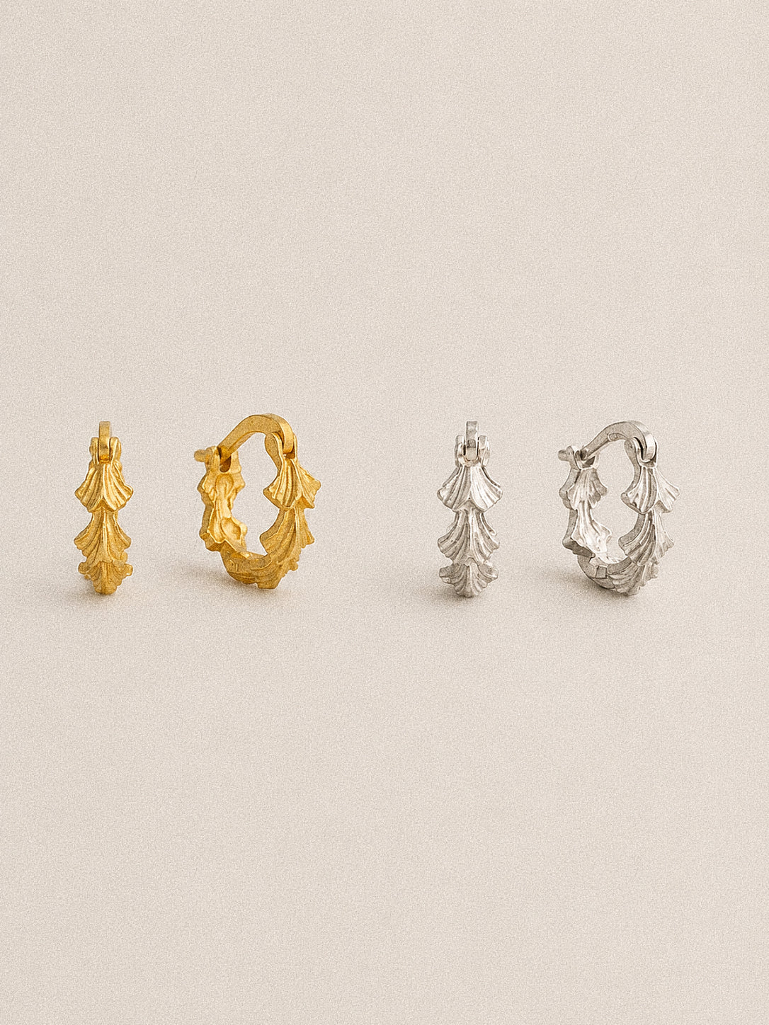 Grove sculpted leaf huggie hoop earrings in gold-plated and sterling silver finishes, shown from front and side.