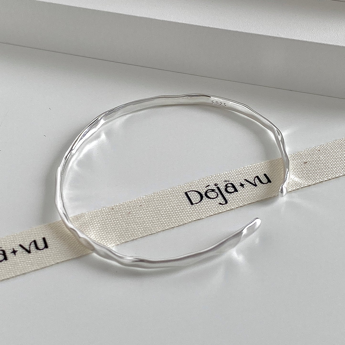 Hammered open cuff bangle in 925 sterling silver with the S925 stamp visible on the polished band