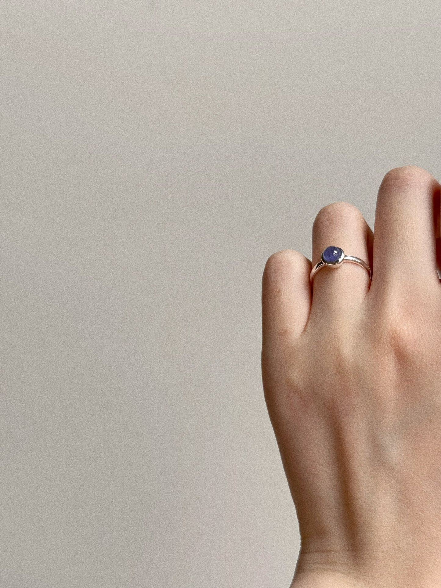 Aesthetic hand shot showing the dainty silver Tanzanite ring, perfect for minimalist daily wear.