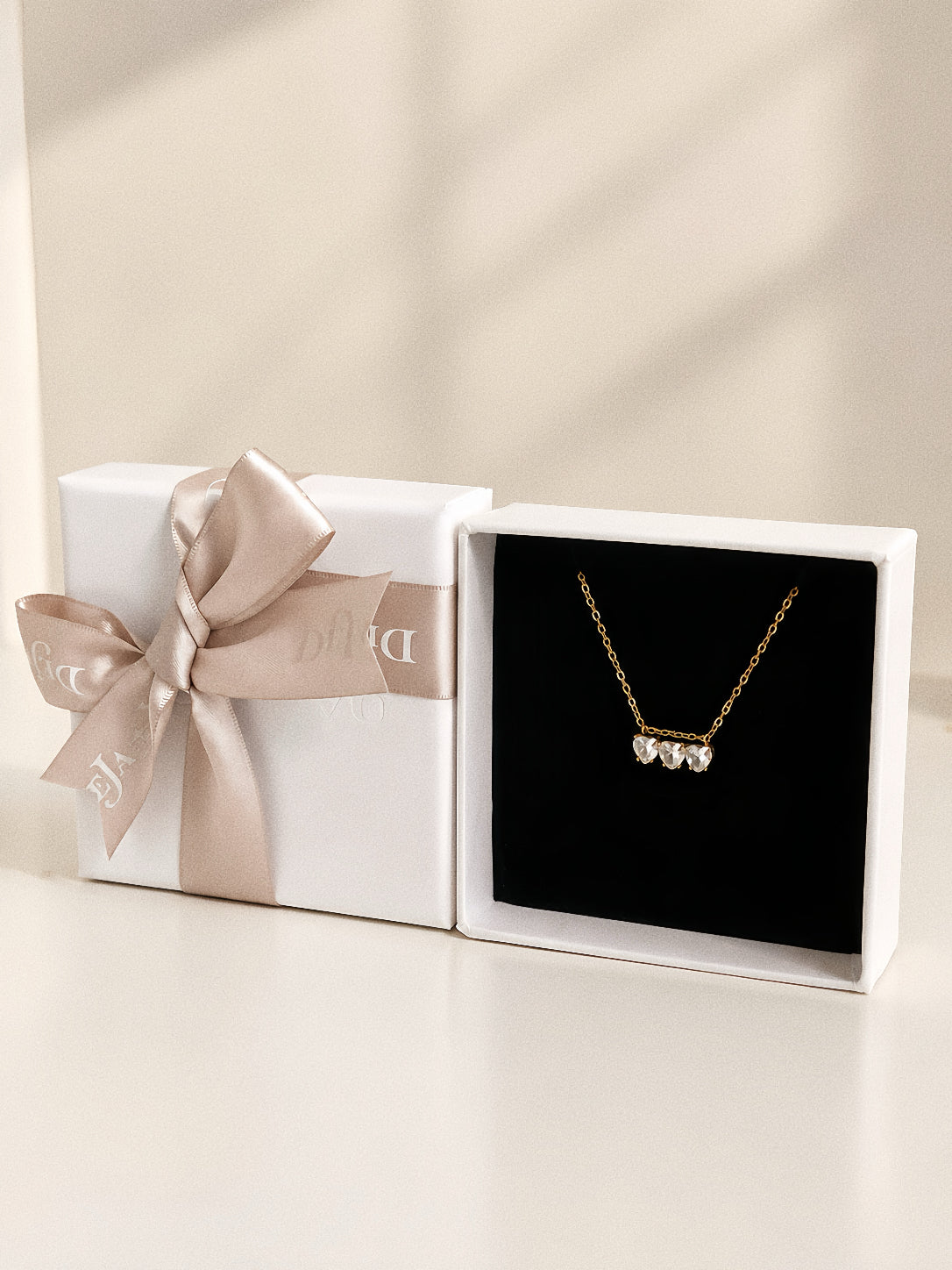Trio three heart necklace presented in a white Deja Vu Jewellery gift box with ribbon