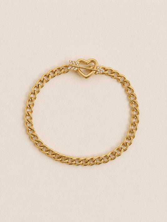 Cupid heart toggle bracelet with curb chain and crystal arrow clasp in 18k gold plated stainless steel
