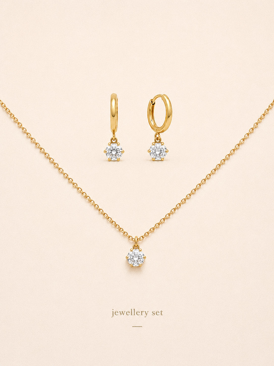 Icon jewellery set with the six claw cz solitaire necklace and matching huggie hoop earrings in 18k gold