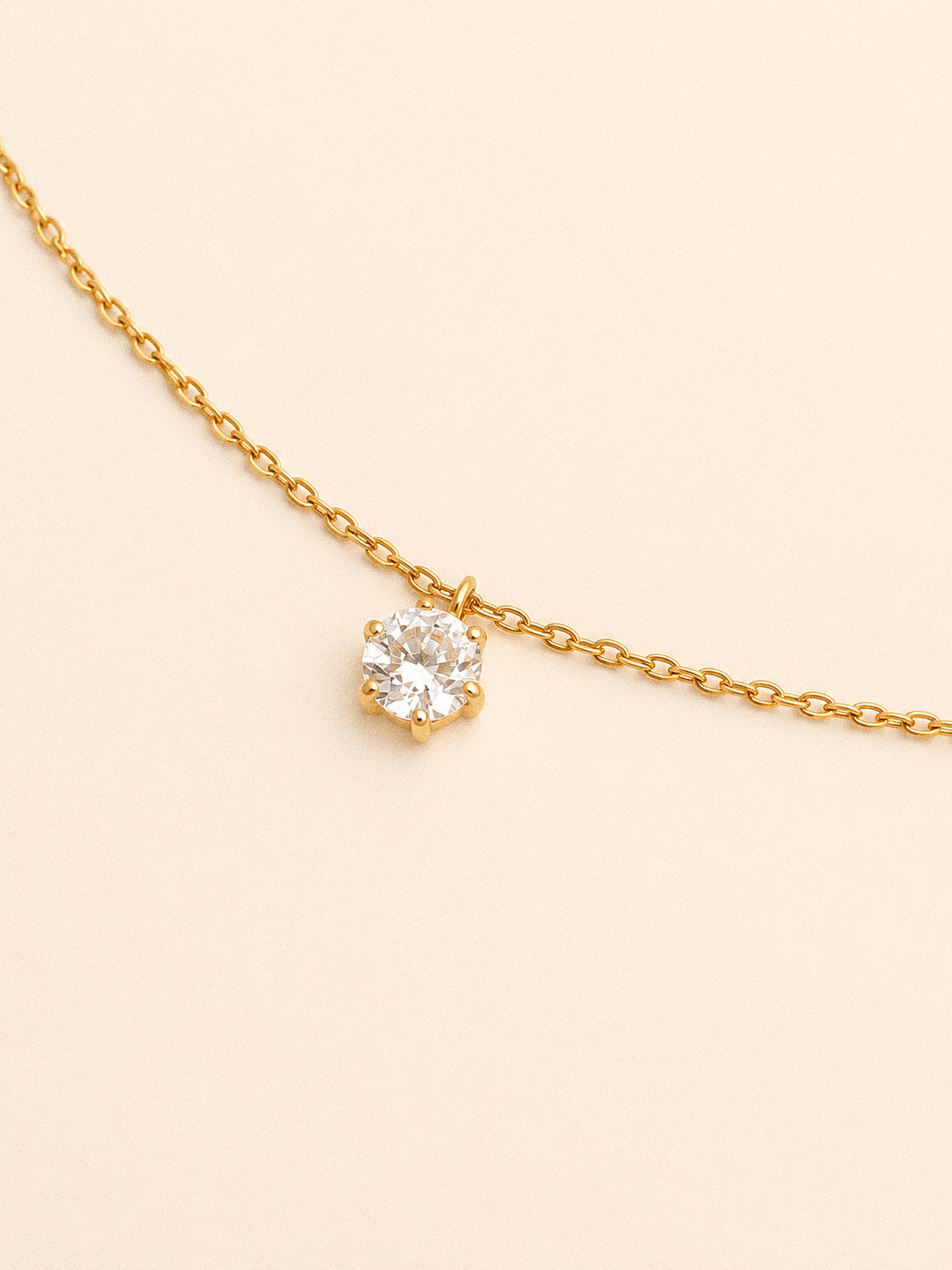 Close up of the six claw cz solitaire pendant from the Icon set on a fine gold chain