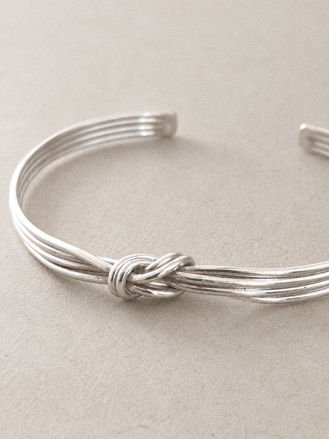 Knot cuff bangle with multi strand 925 sterling silver wires hand tied into a central reef knot