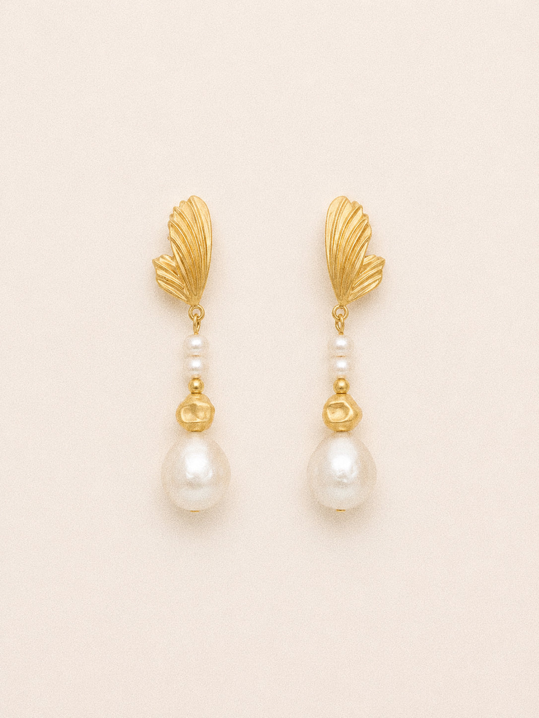 Linden long baroque pearl drop earrings with sculpted gold leaf studs, petite pearl accents and 11 mm freshwater pearls.