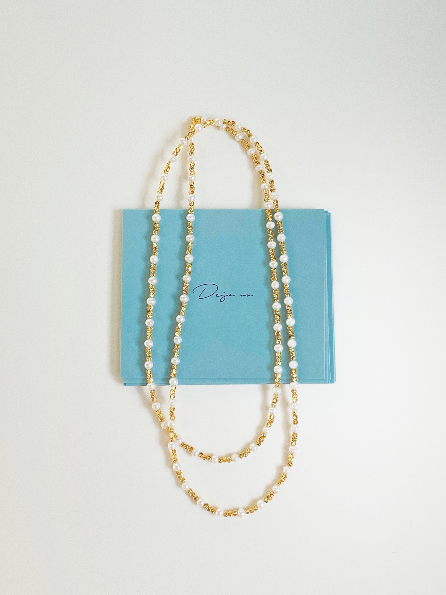 Constellation long pearl necklace styled with Deja Vu Jewellery branded gift card