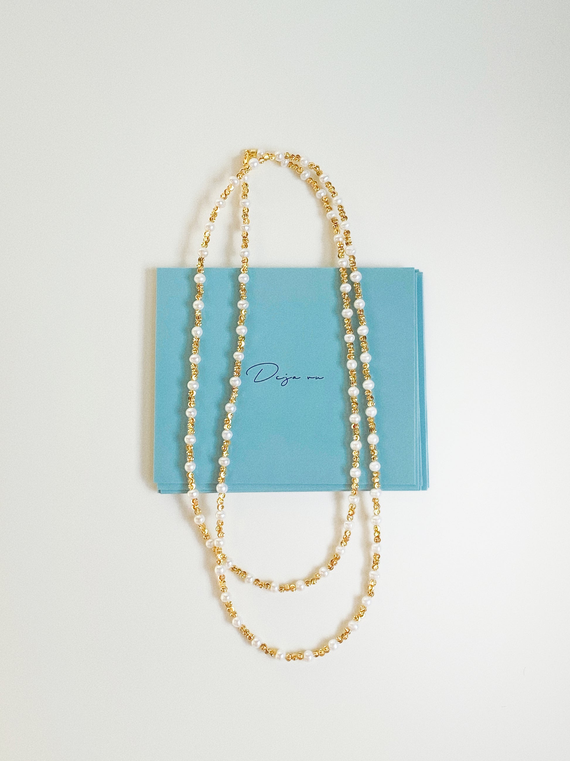 Constellation long pearl necklace styled with Deja Vu Jewellery branded gift card