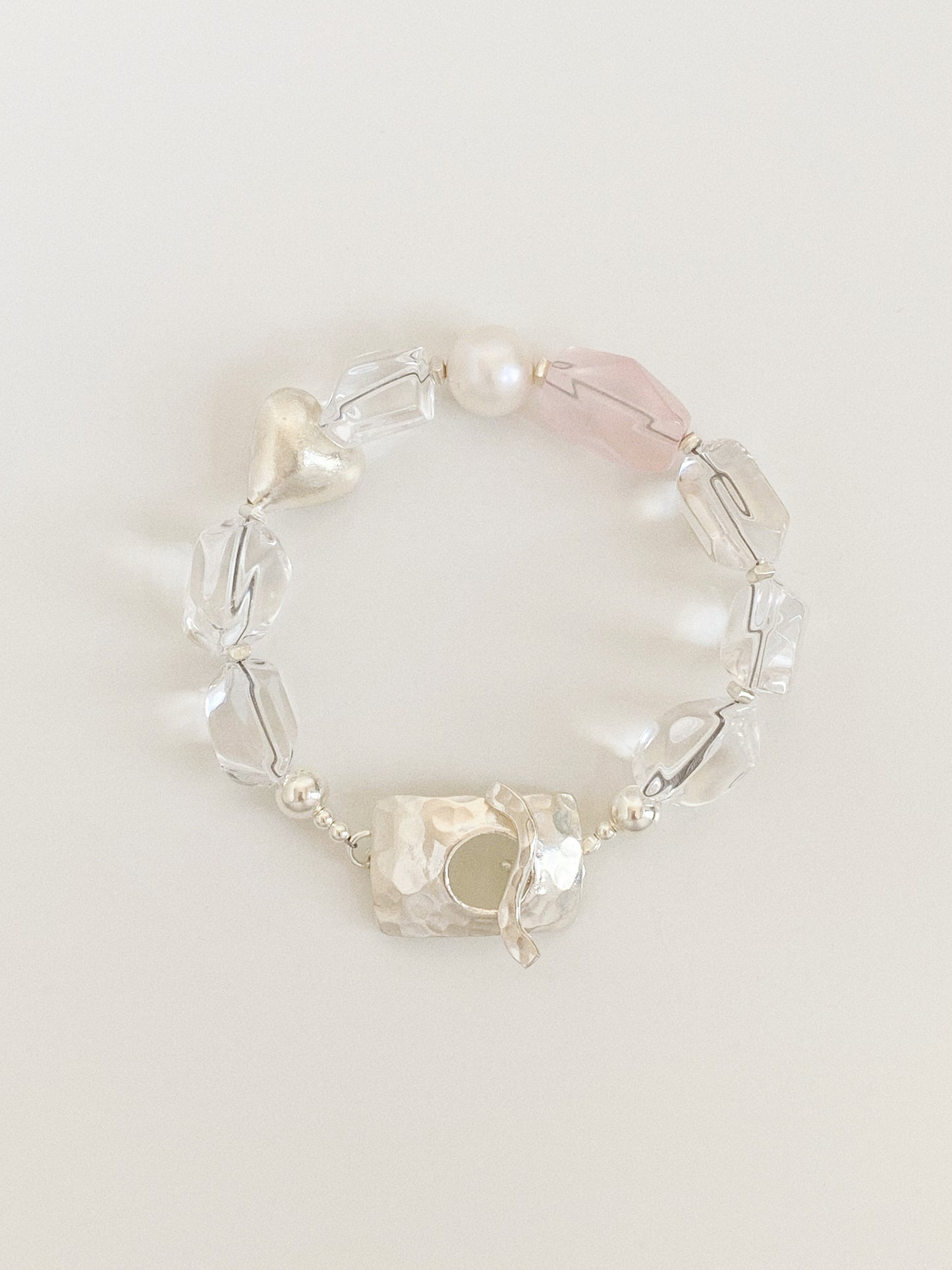 Handmade bracelet of chunky faceted clear quartz nuggets, rose quartz, freshwater pearl and a brushed silver heart with a hammered 925 clasp