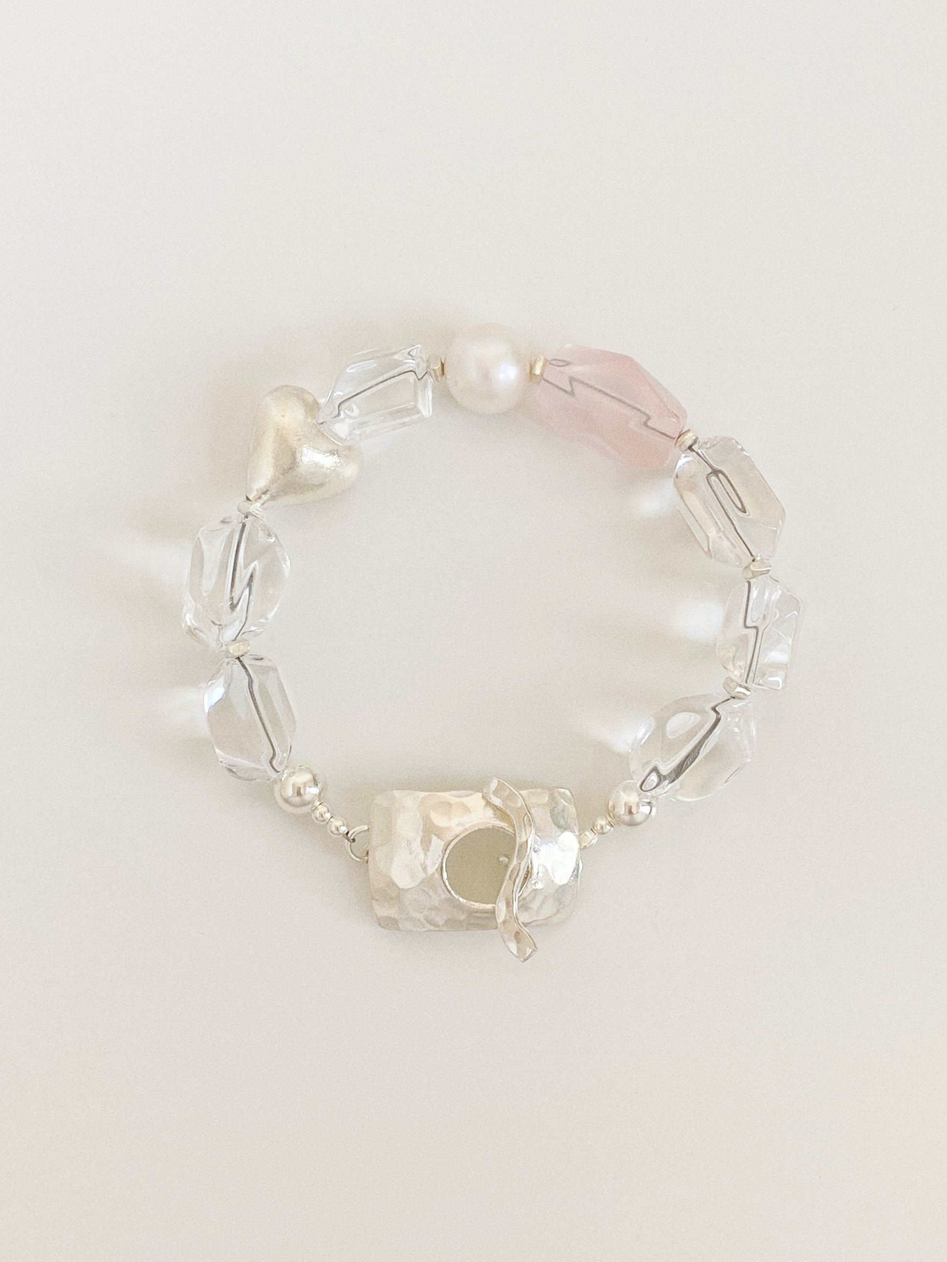 Handmade bracelet of chunky faceted clear quartz nuggets, rose quartz, freshwater pearl and a brushed silver heart with a hammered 925 clasp