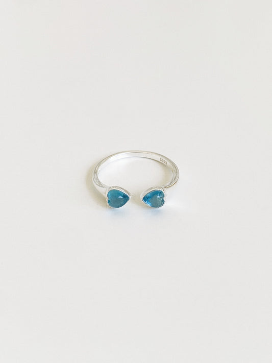 Adjustable open sterling silver ring with two natural aquamarine heart stones facing each other, S925 hallmark visible