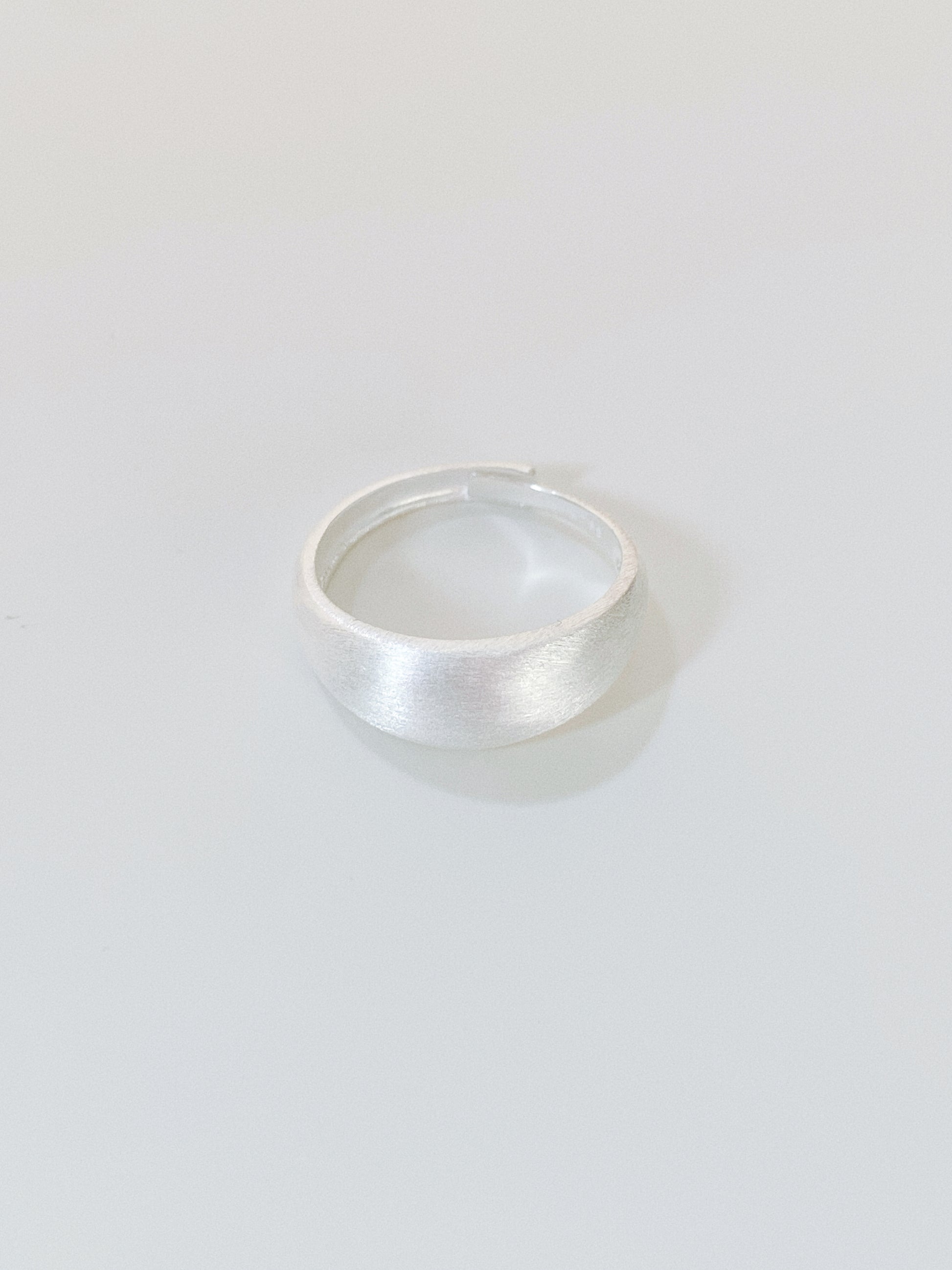 A minimalist 925 sterling silver dome ring with a hand-brushed matte finish on a clean white background.