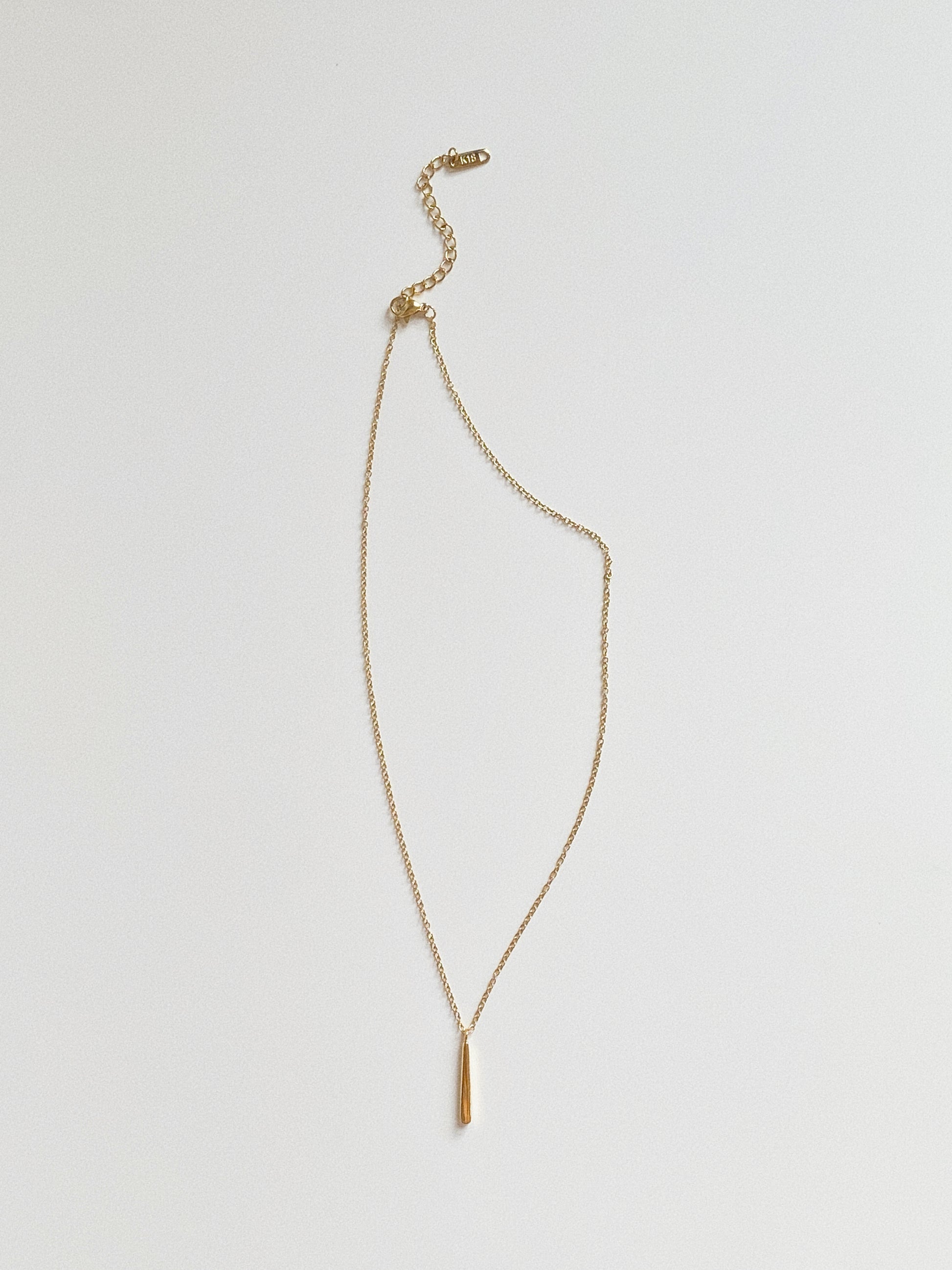 Back view of gold vertical bar necklace showing adjustable 5cm extender chain.