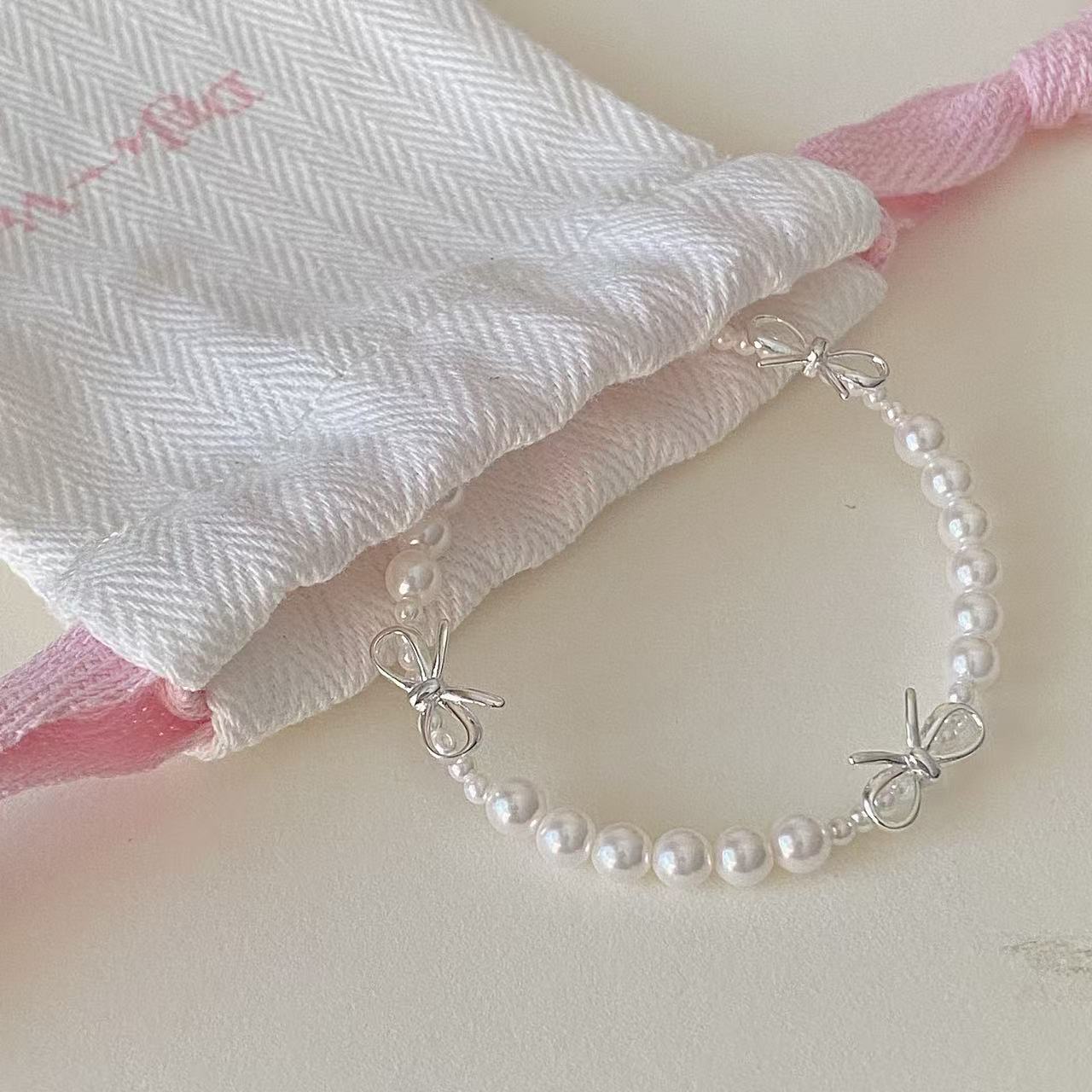 Dainty bow pearl bracelet close-up for bridesmaid gift