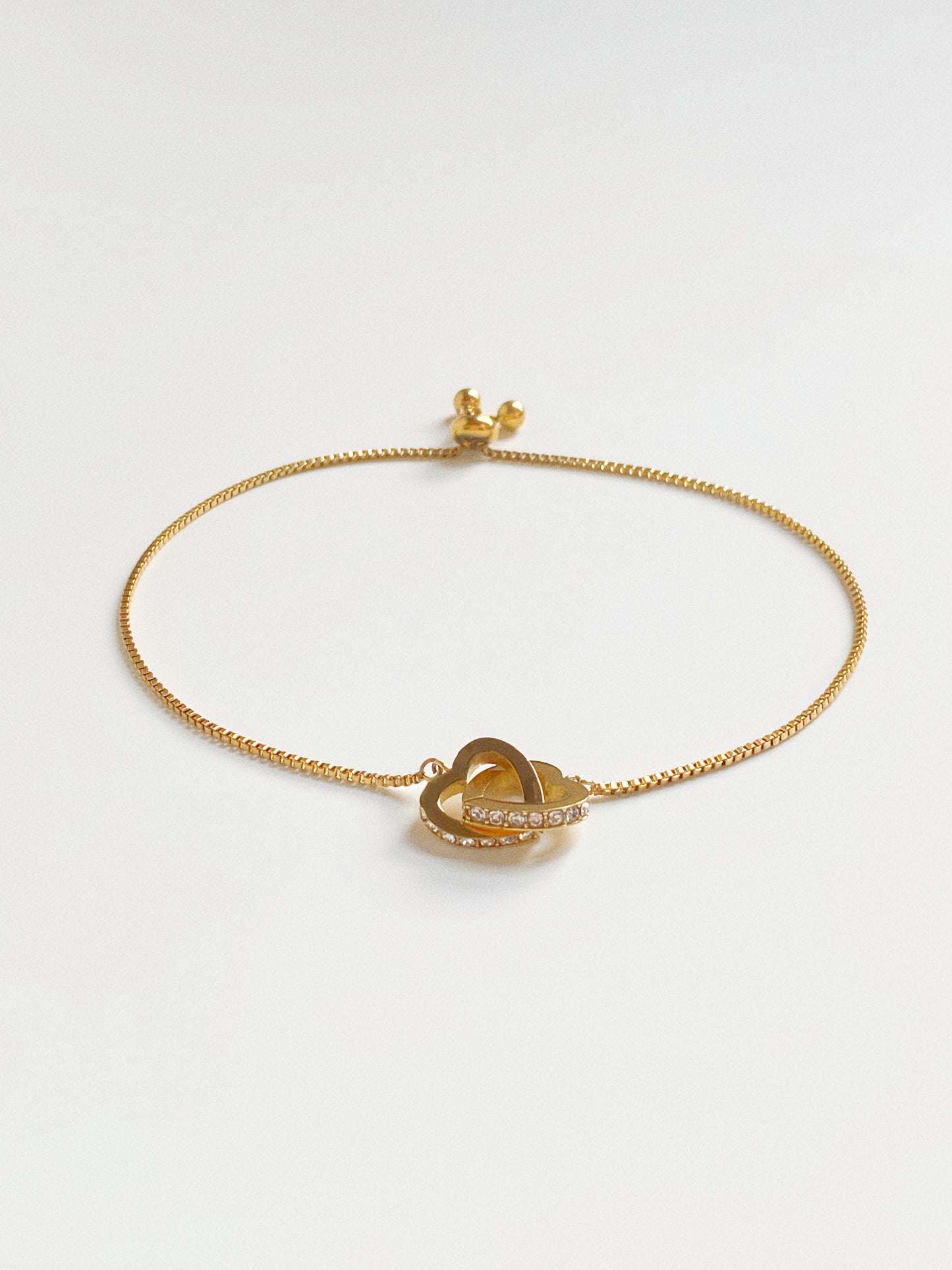 Full view of gold connected hearts slider bracelet showing the maximum 24cm adjustable length.