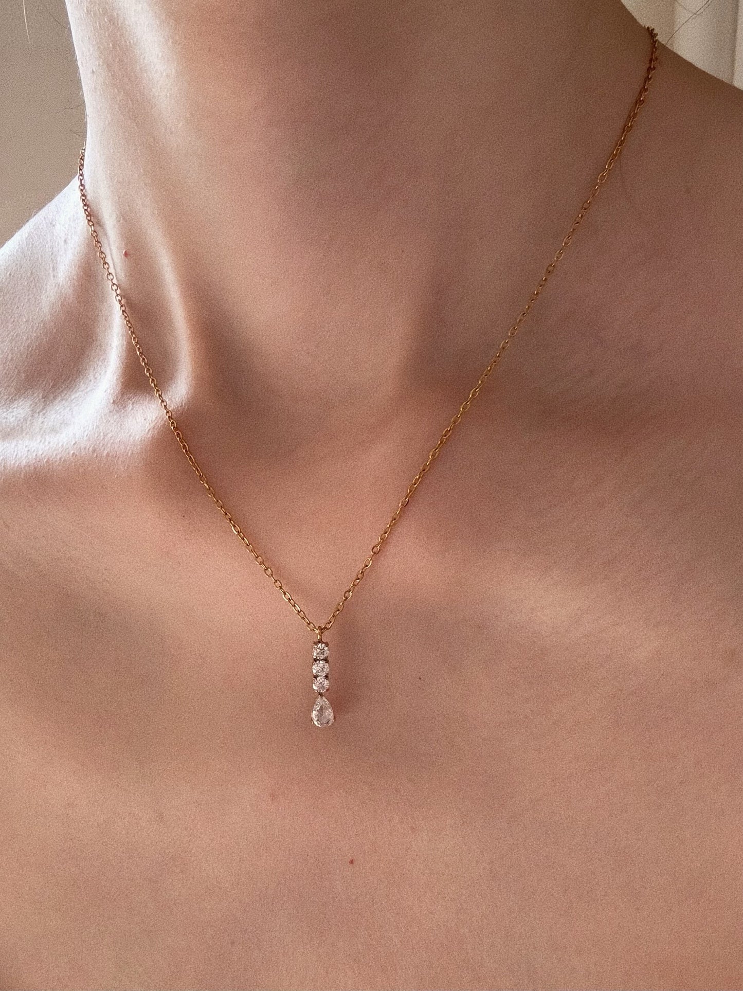 Model wearing The Vienna Teardrop Necklace on collarbone, showcasing the 1.9cm pendant size.
