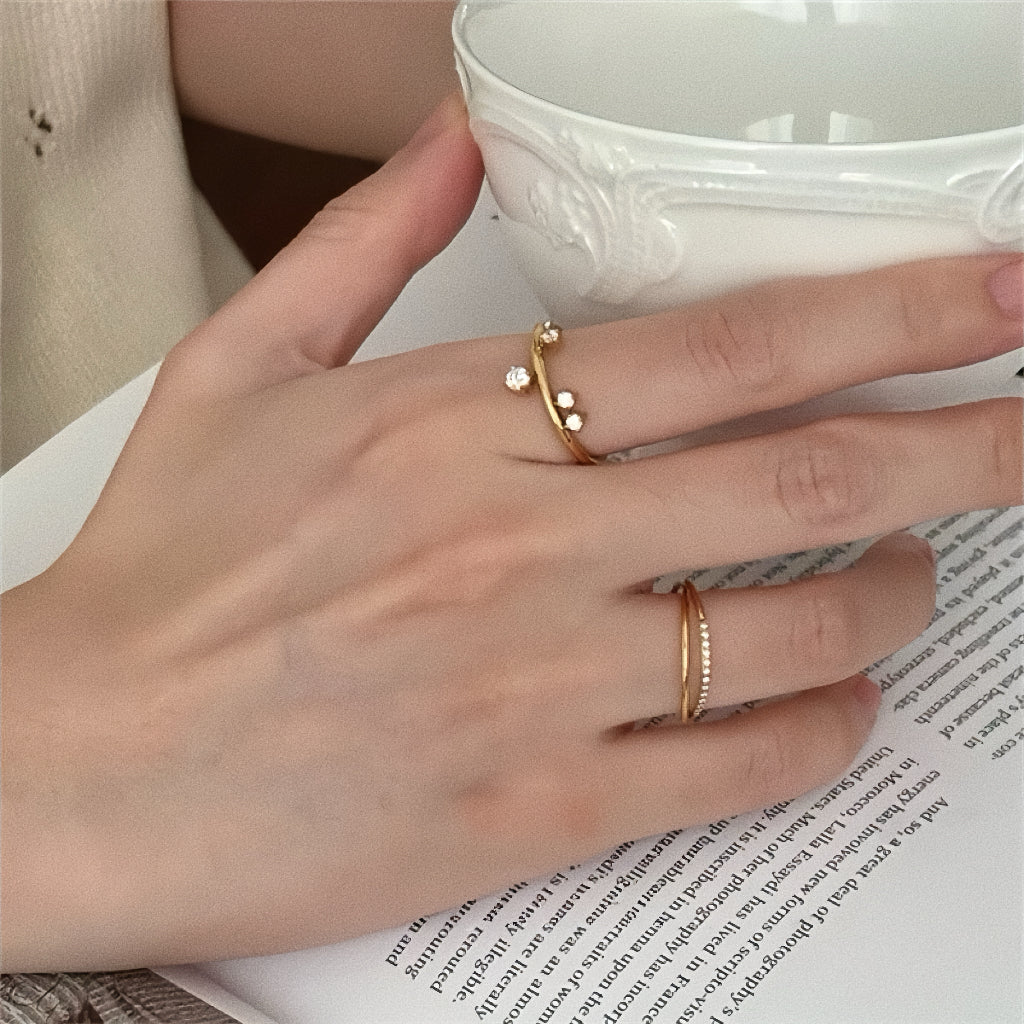 Model wearing dainty gold scattered stone ring, styled for a minimalist aesthetic.