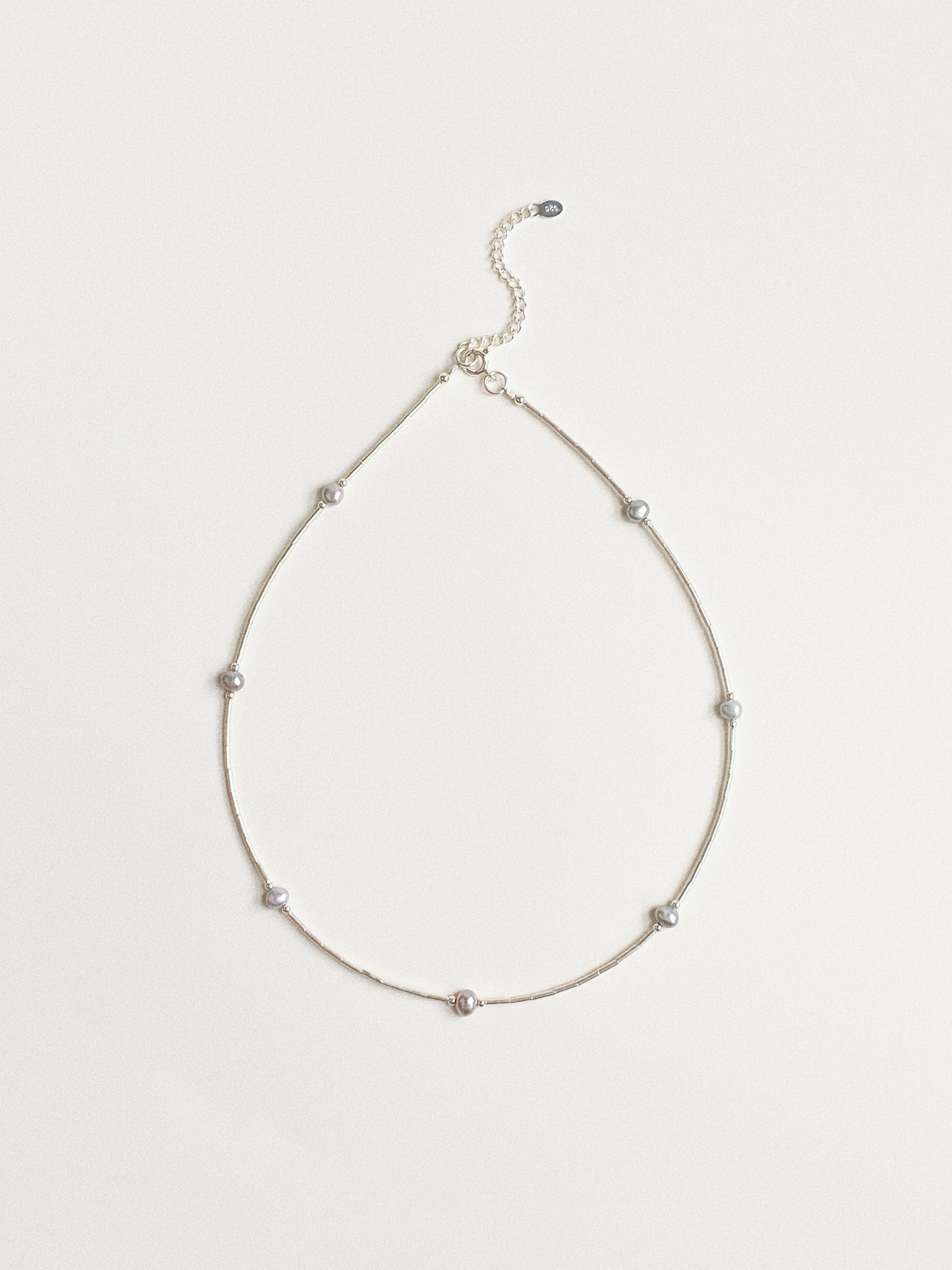 Misty grey freshwater pearl station necklace on fine 925 sterling silver chain flat lay by Deja Vu Jewellery