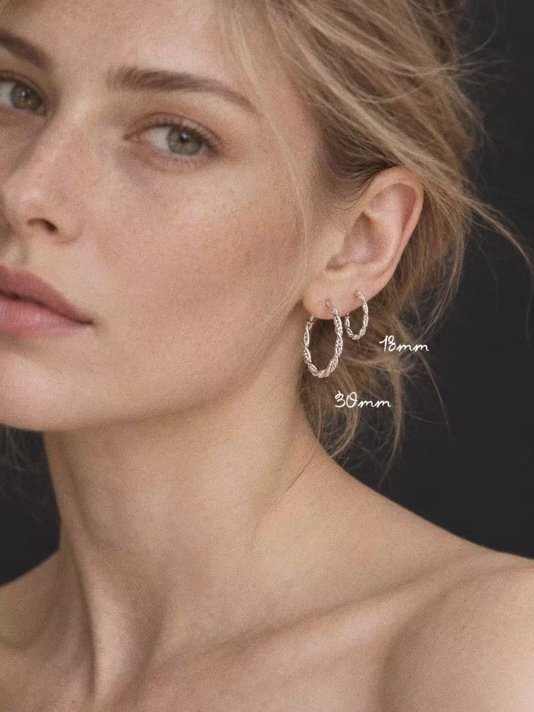 18mm and 30mm Mobius sterling silver twisted hoops worn together to show their relative sizes