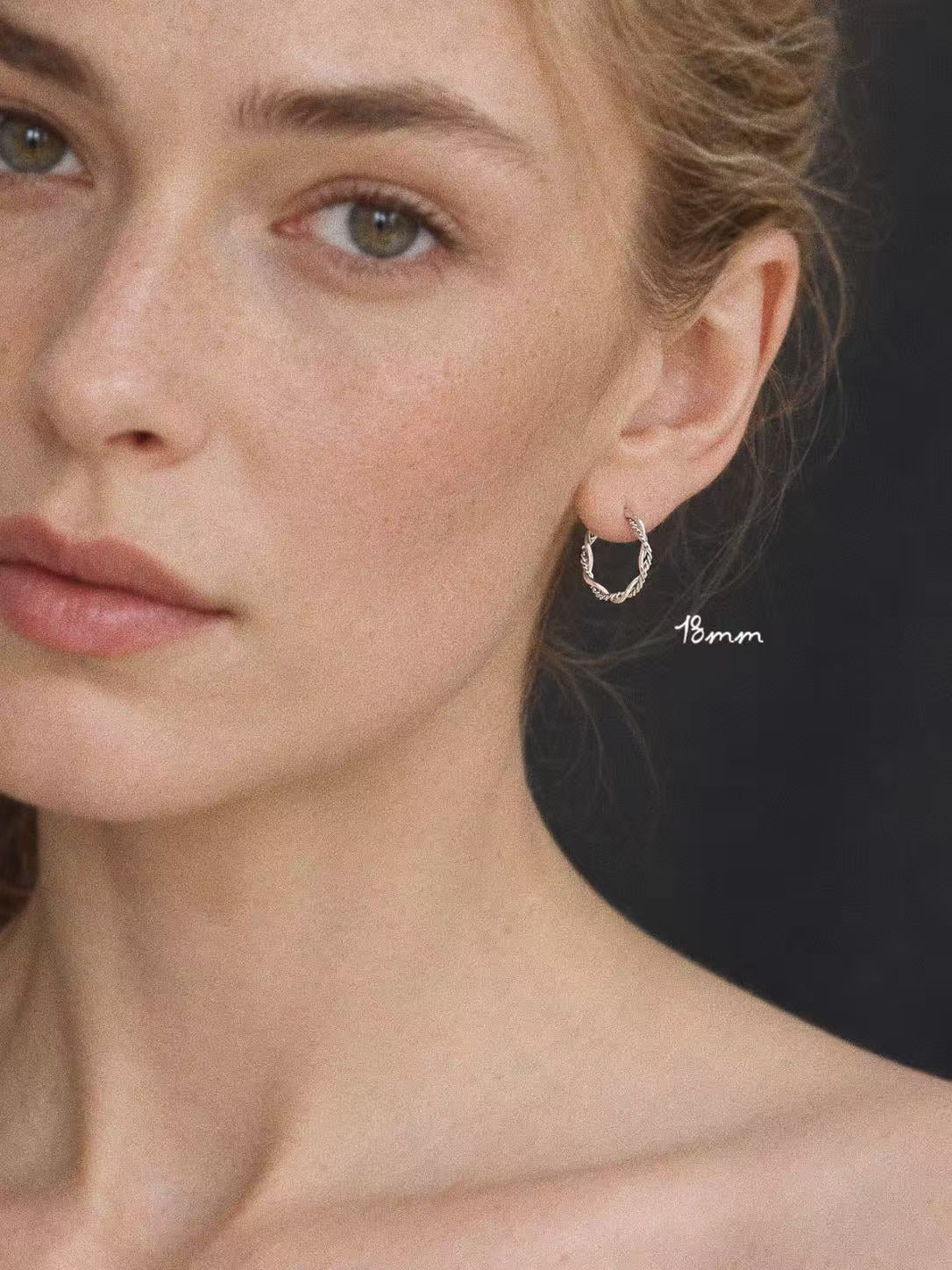 Model wearing the 18mm Mobius sterling silver twisted hoop earring