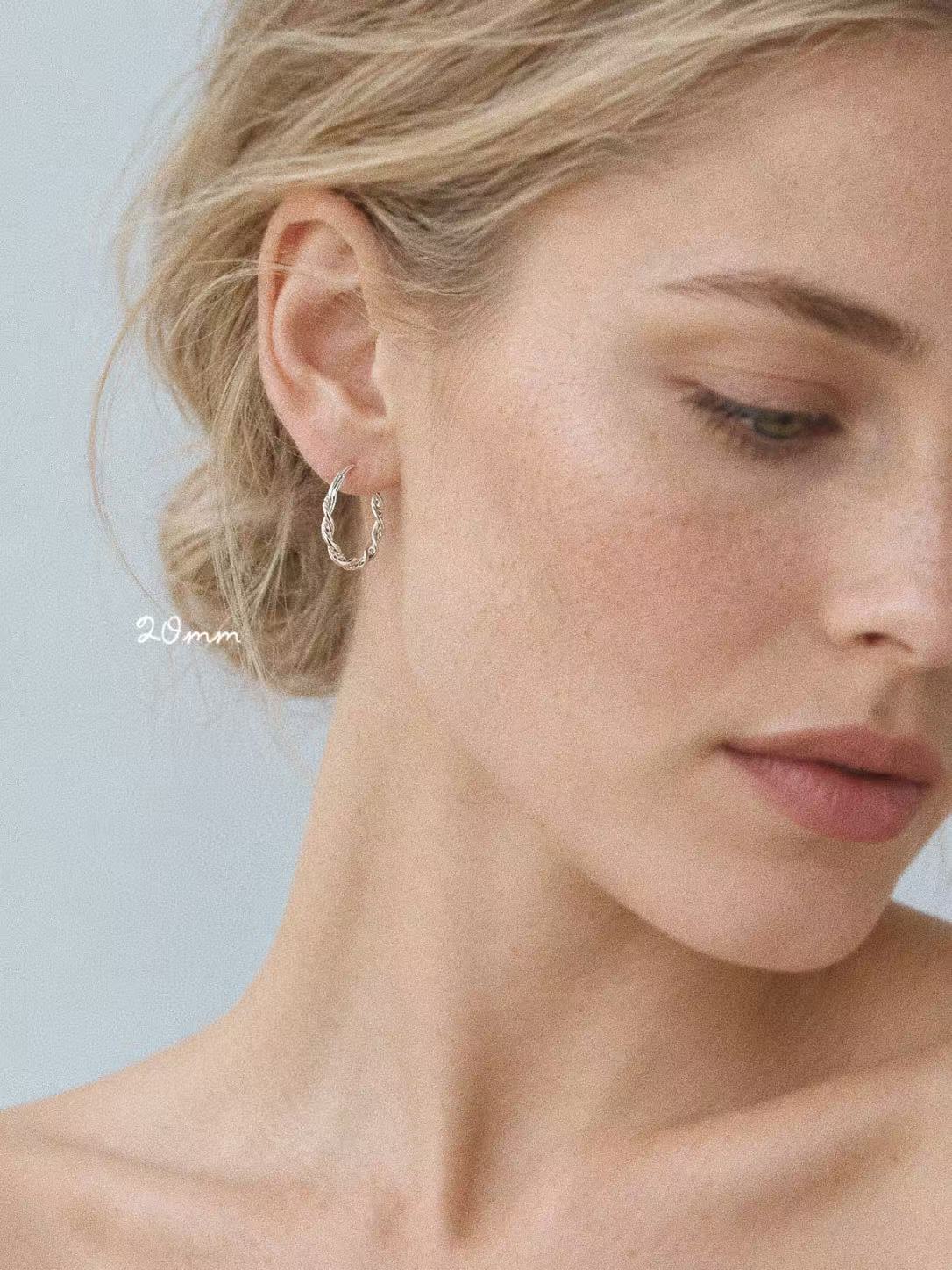 Model wearing the 20mm Mobius sterling silver twisted hoop earring
