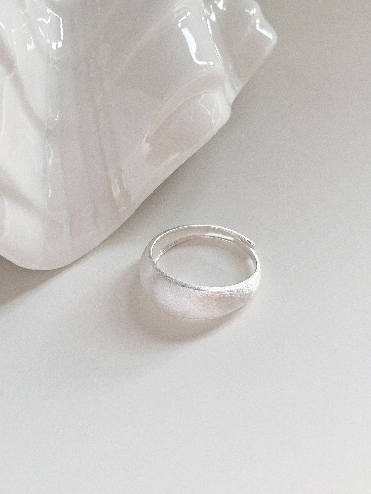 Top view of the Mellow adjustable silver ring showing the thick, rounded band and fine brushed detailing.