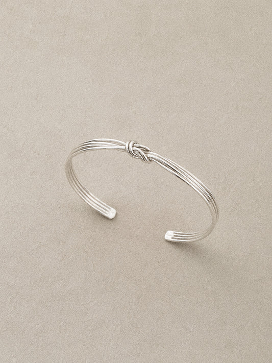 Angled view of the multi strand wire bangle with the knot sitting at the centre of the band