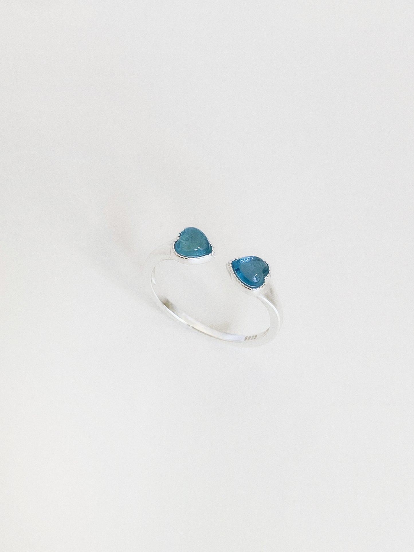  Natural aquamarine double heart ring standing upright, showing the soft blue tone of the March birthstone hearts