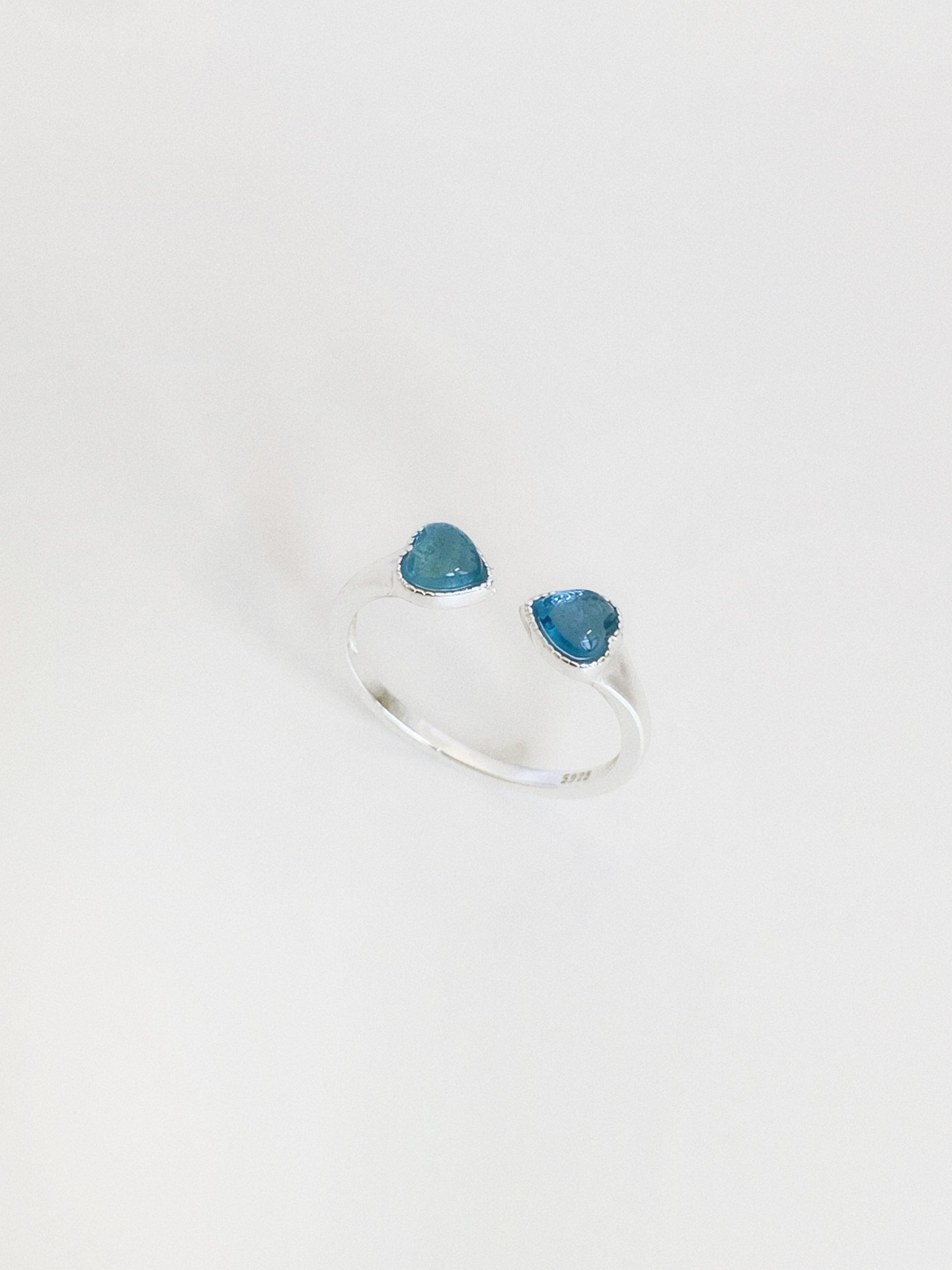  Natural aquamarine double heart ring standing upright, showing the soft blue tone of the March birthstone hearts