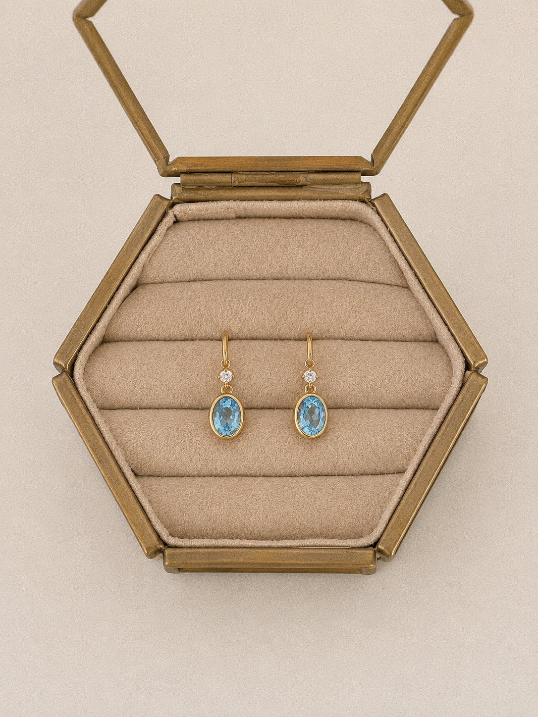 Tide natural Swiss blue topaz earrings presented as a pair in a Deja vu Jewellery gift box.