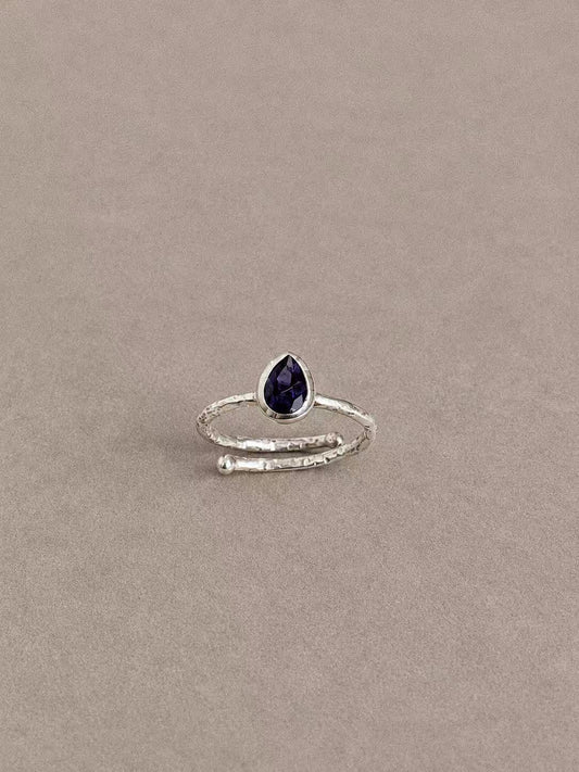 Natural iolite teardrop ring in 925 sterling silver with a textured overlapping band, front view