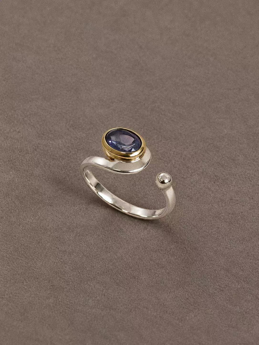 Natural iolite two-tone open ring with a blue-violet oval gemstone, sterling silver band and brass bezel