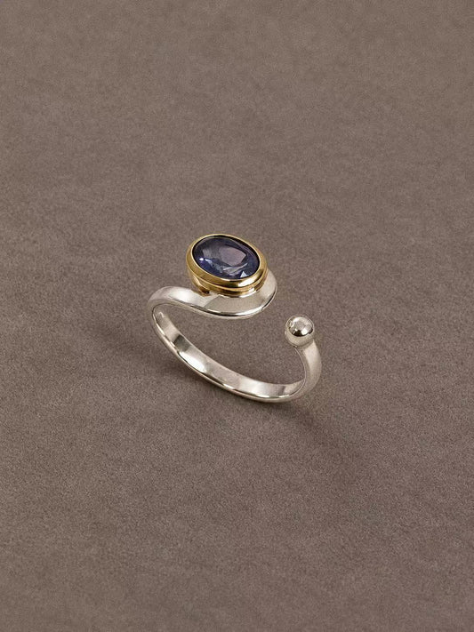 Natural iolite two-tone open ring with a blue-violet oval gemstone, sterling silver band and brass bezel