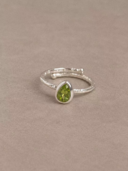 Natural peridot teardrop ring in 925 sterling silver with a textured band, front view