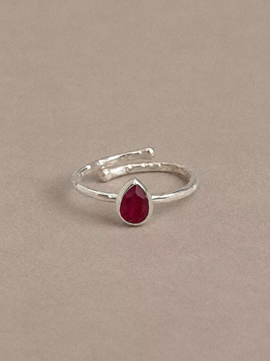 Natural ruby teardrop ring in 925 sterling silver with a textured band, front view