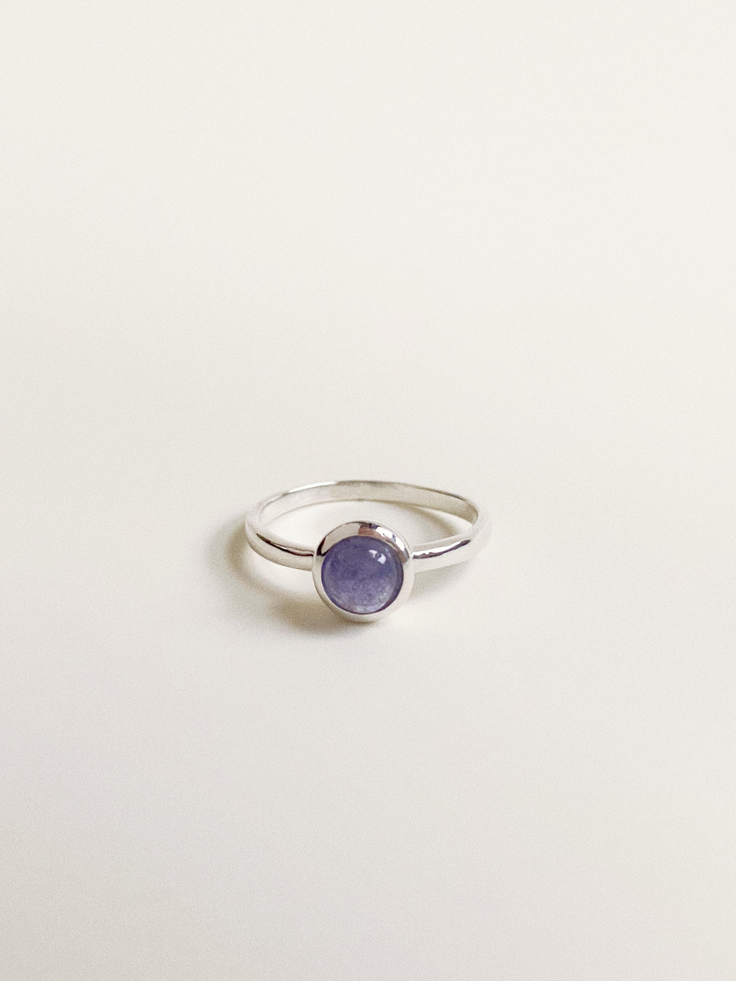 Front view of the Bubble Solitaire Ring featuring a 5mm natural Tanzanite cabochon in a silver bezel setting.
