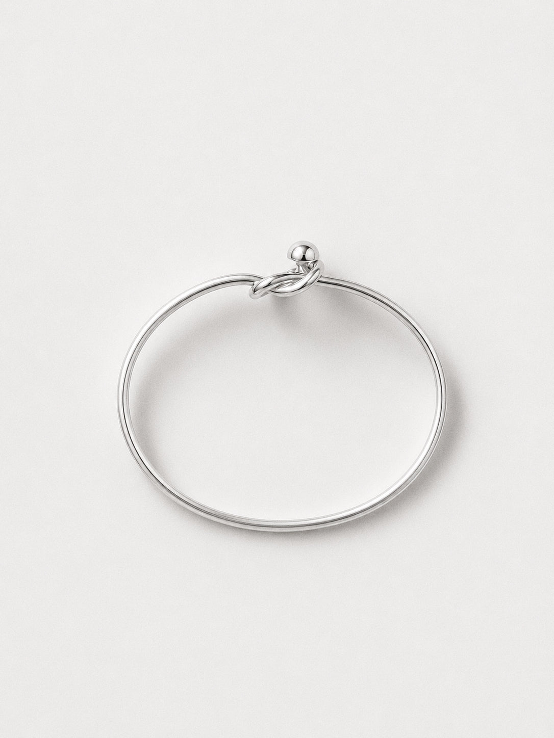 Top view of the open cuff sterling silver love knot bangle showing the oval shape and slip-on opening