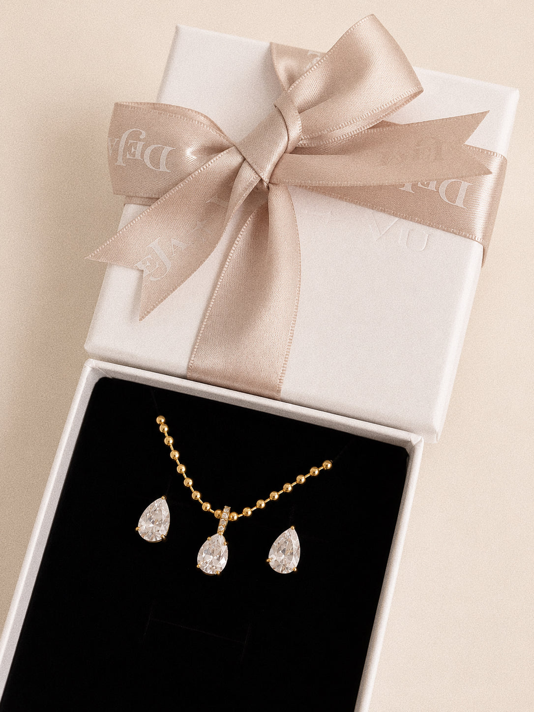 Dew pear stud earrings in a Deja Vu gift box with the matching teardrop necklace from the Dew Collection