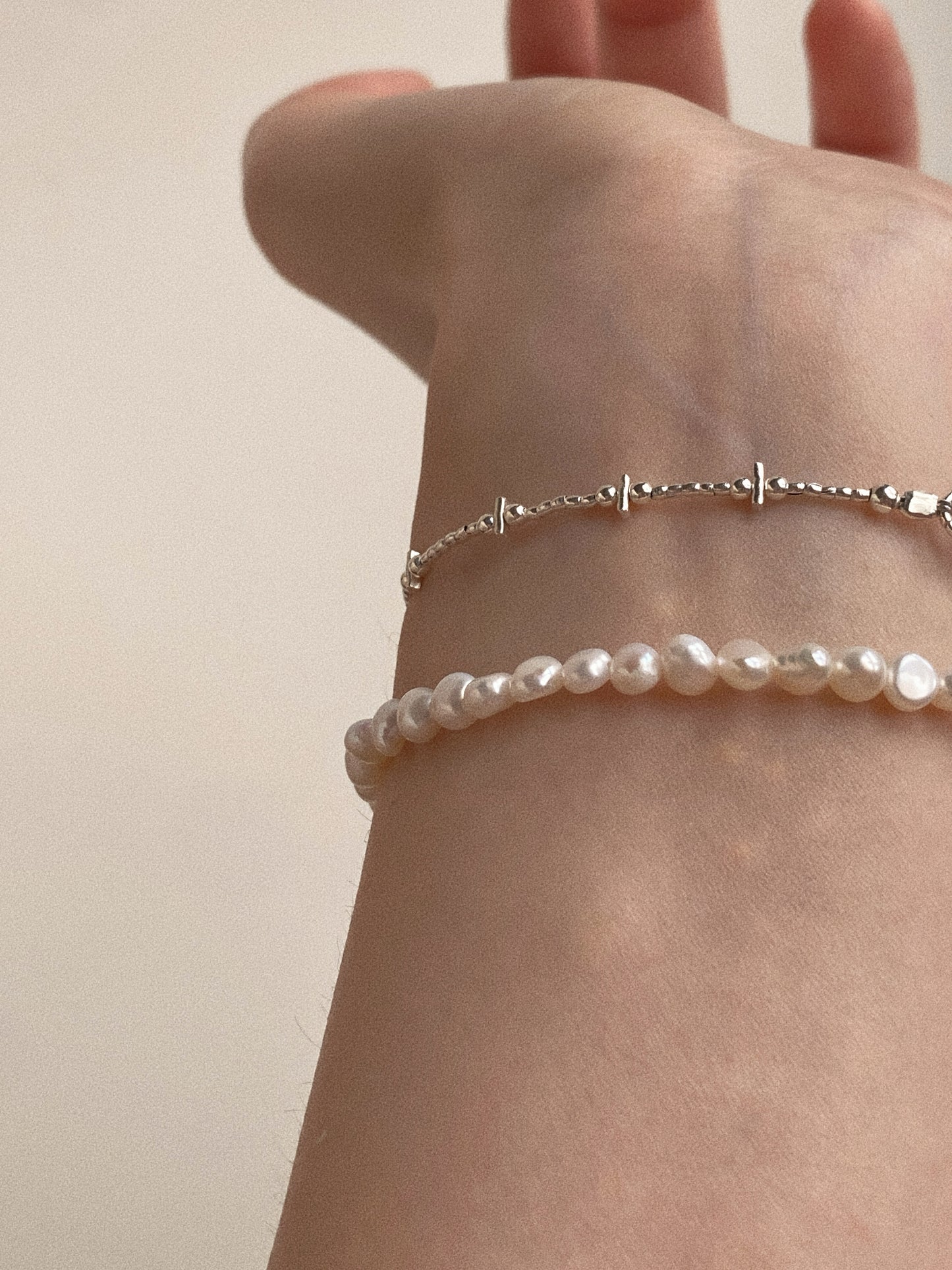 Styling inspiration: The Petite Baroque Pearl Bracelet stacked with a minimalist silver bar bracelet.