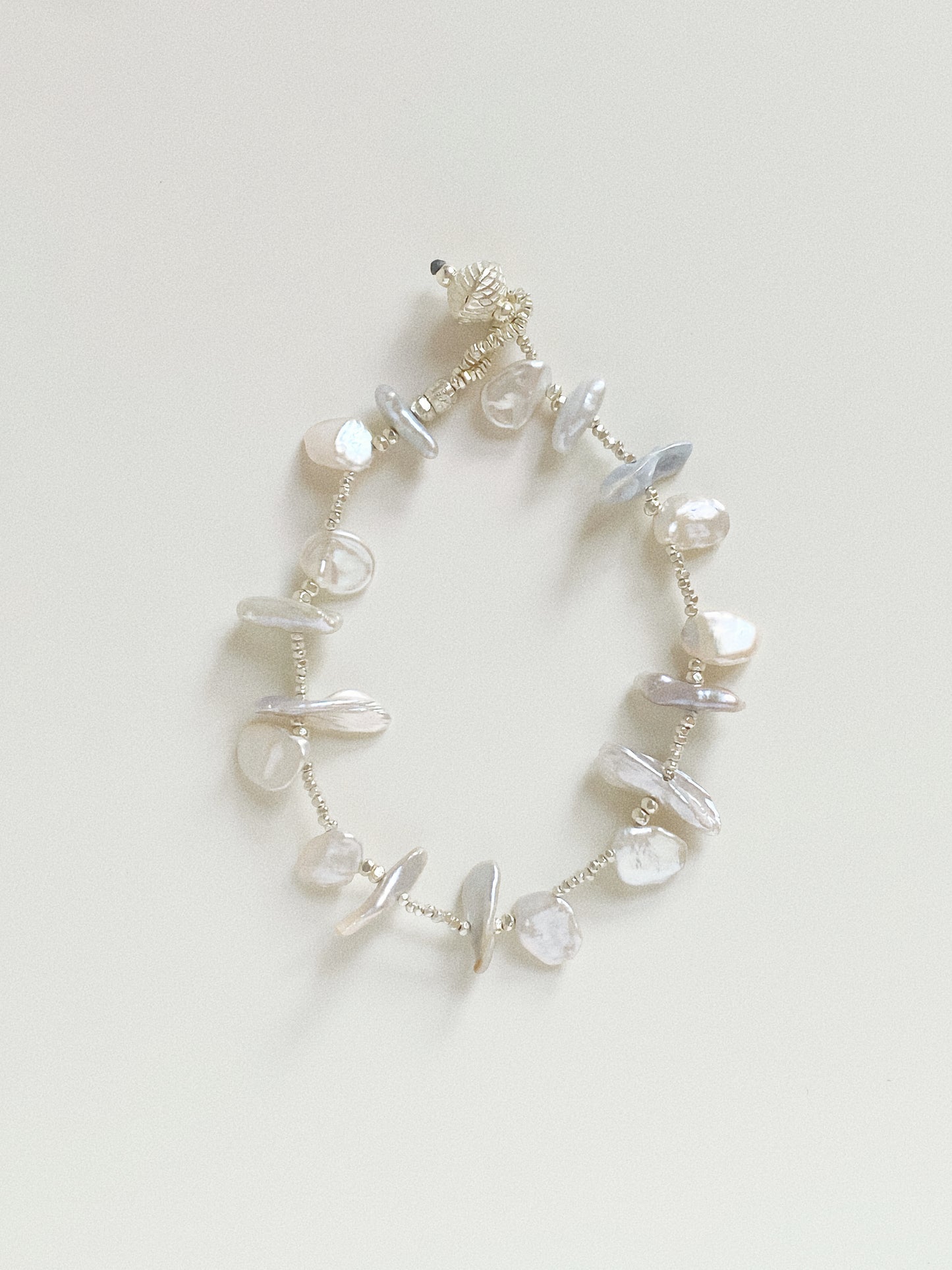 Full view of the Ocean Petal Pearl Bracelet, showing the 18cm length and organic arrangement of natural gems.