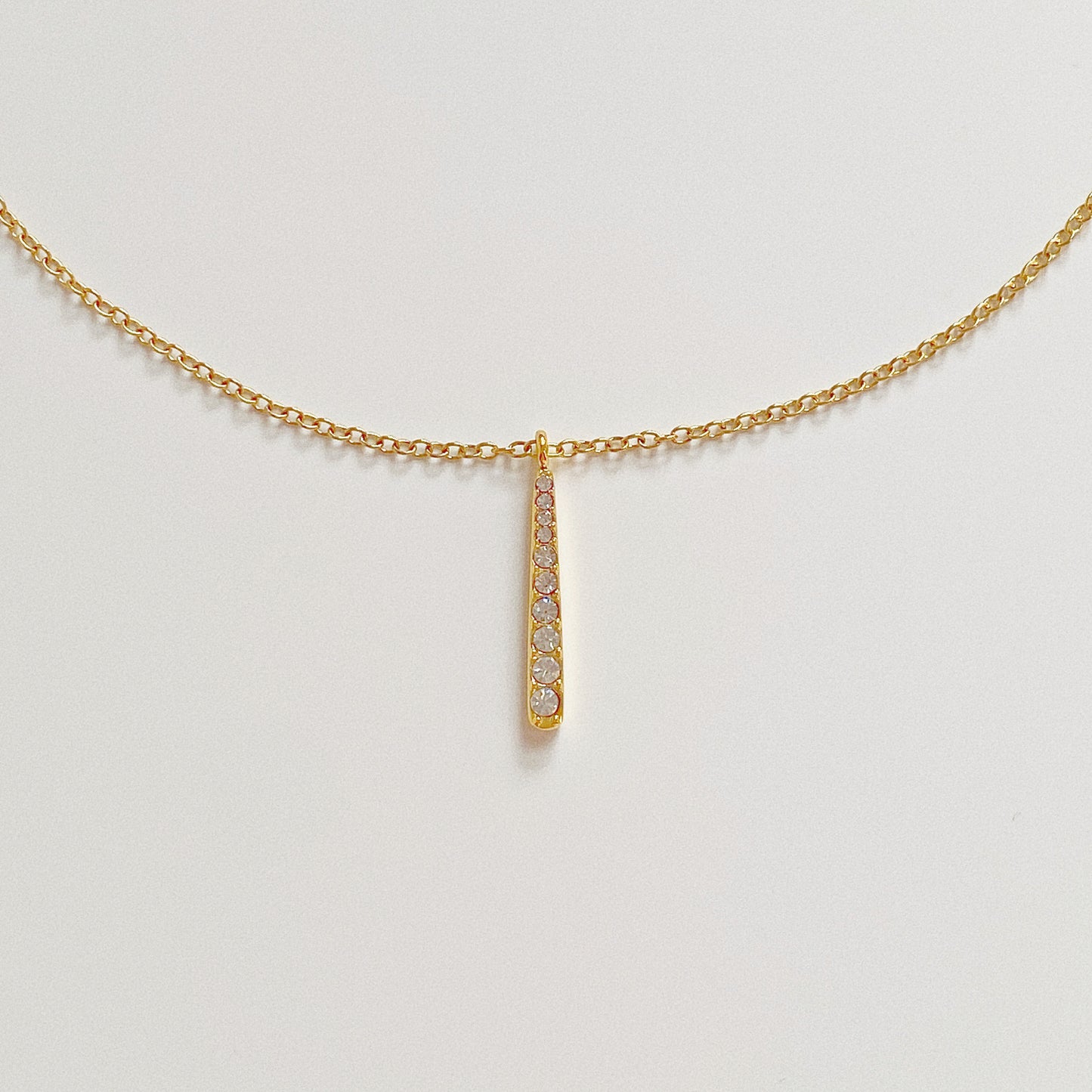 Gold waterproof necklace featuring a 2.3cm vertical bar pendant set with sparkling crystals.