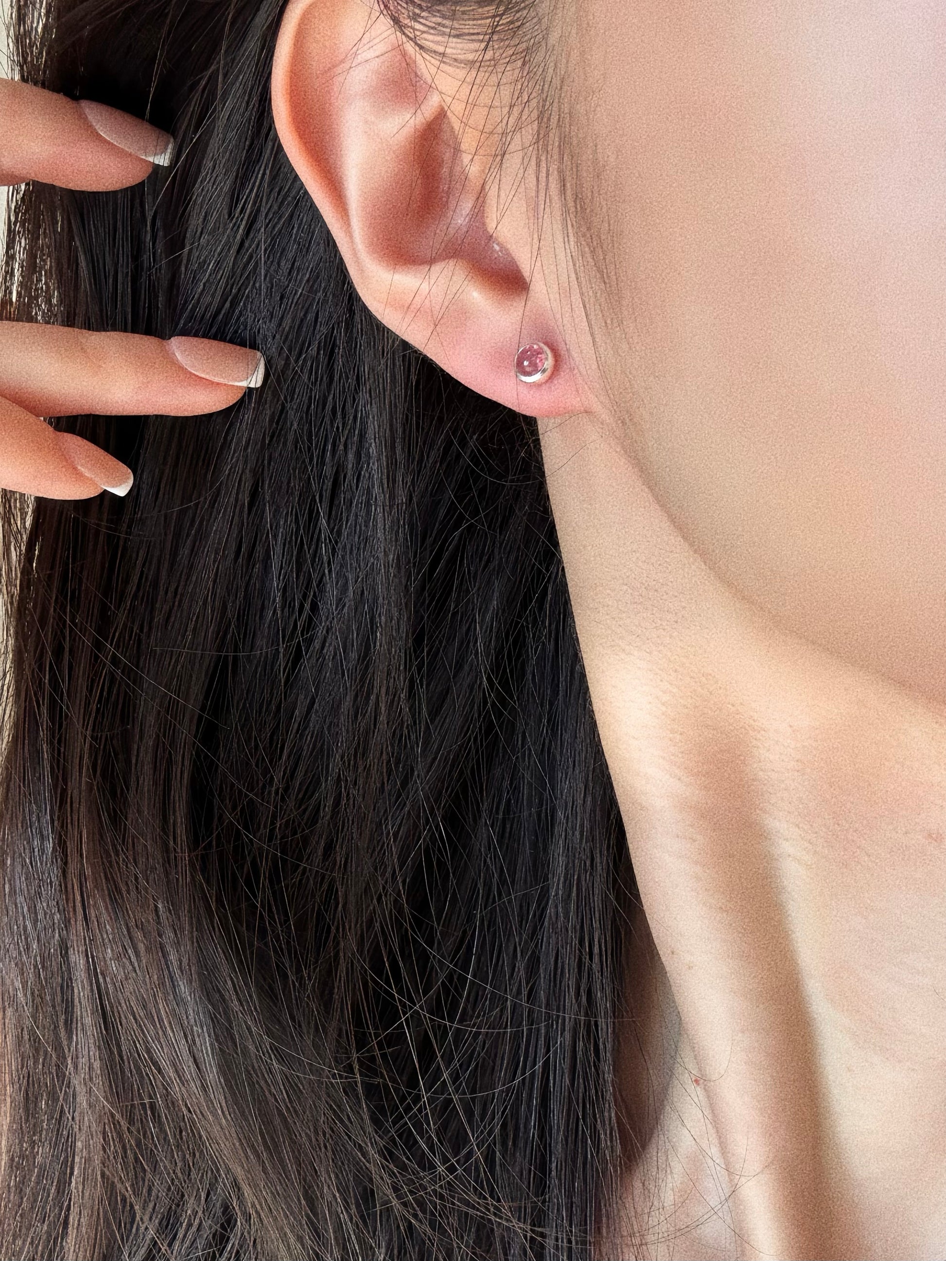 Model wearing the Pink Tourmaline Bubble Stud on the earlobe, showcasing the soft rose color and dainty size.